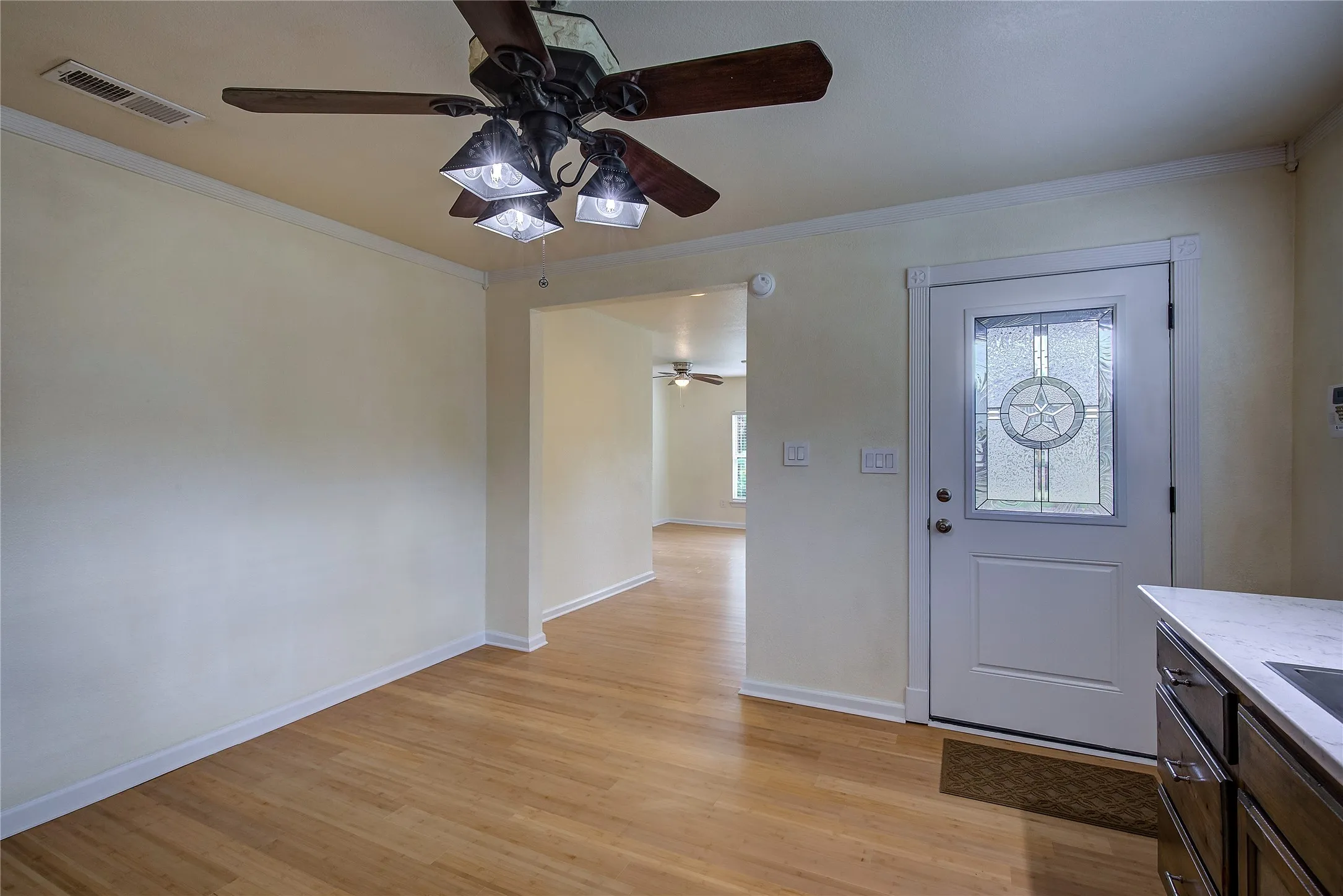 Looking from the kitchen toward the living/nook area and outside entry.