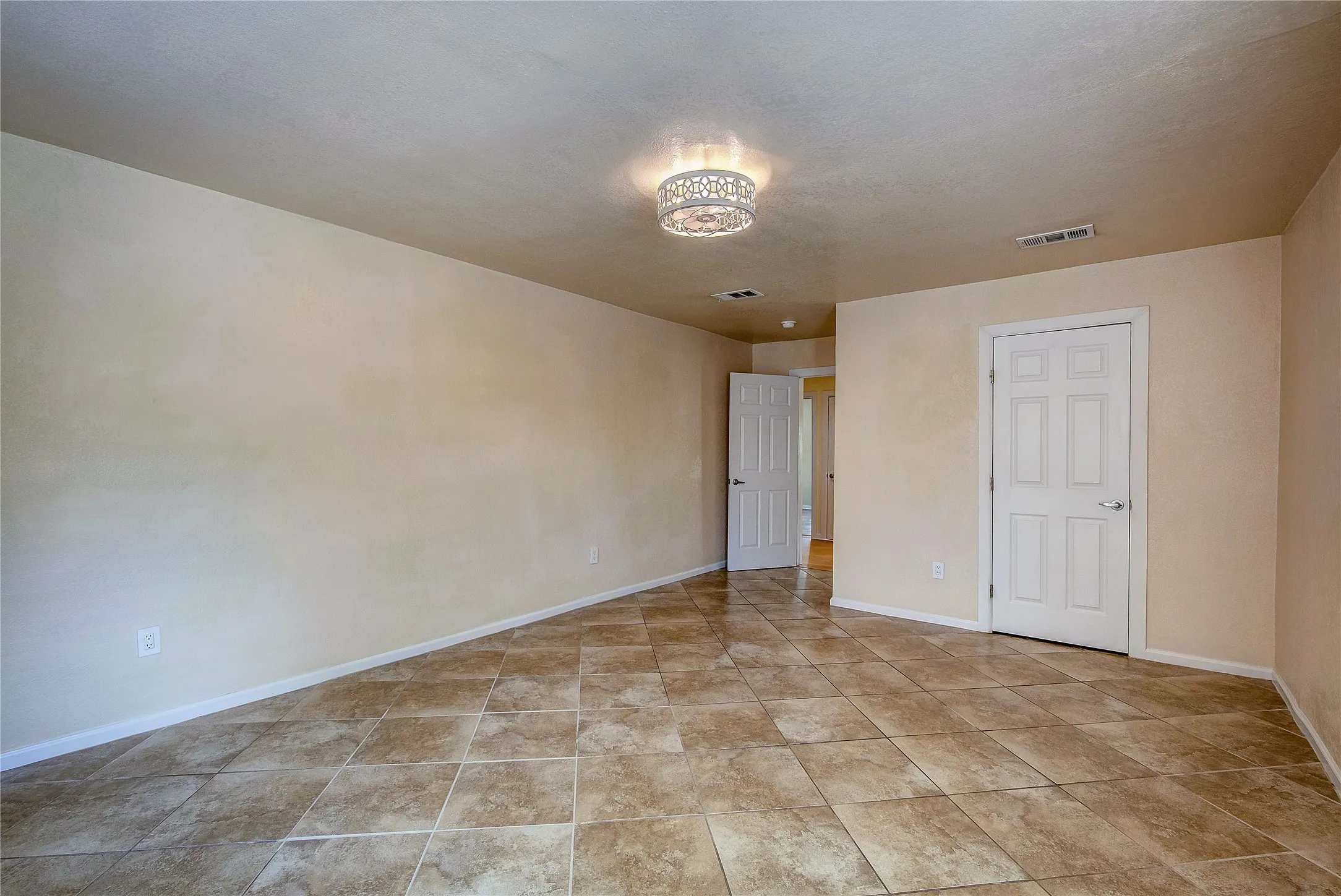 Secondary bedroom with c-tile flooring and combo ceiling fan and light fixture.