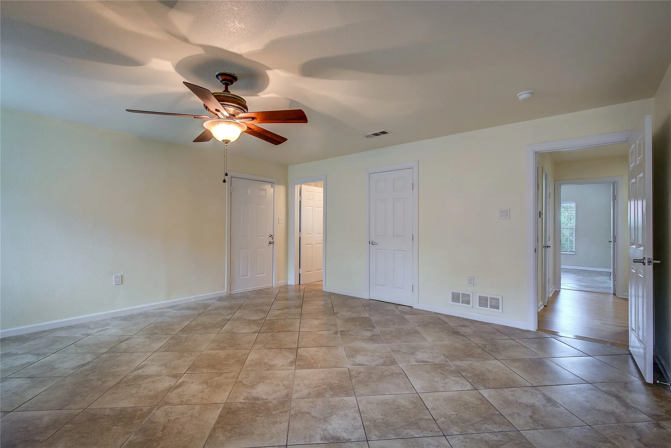 View of the primary bedroom with bath entry and hall in view