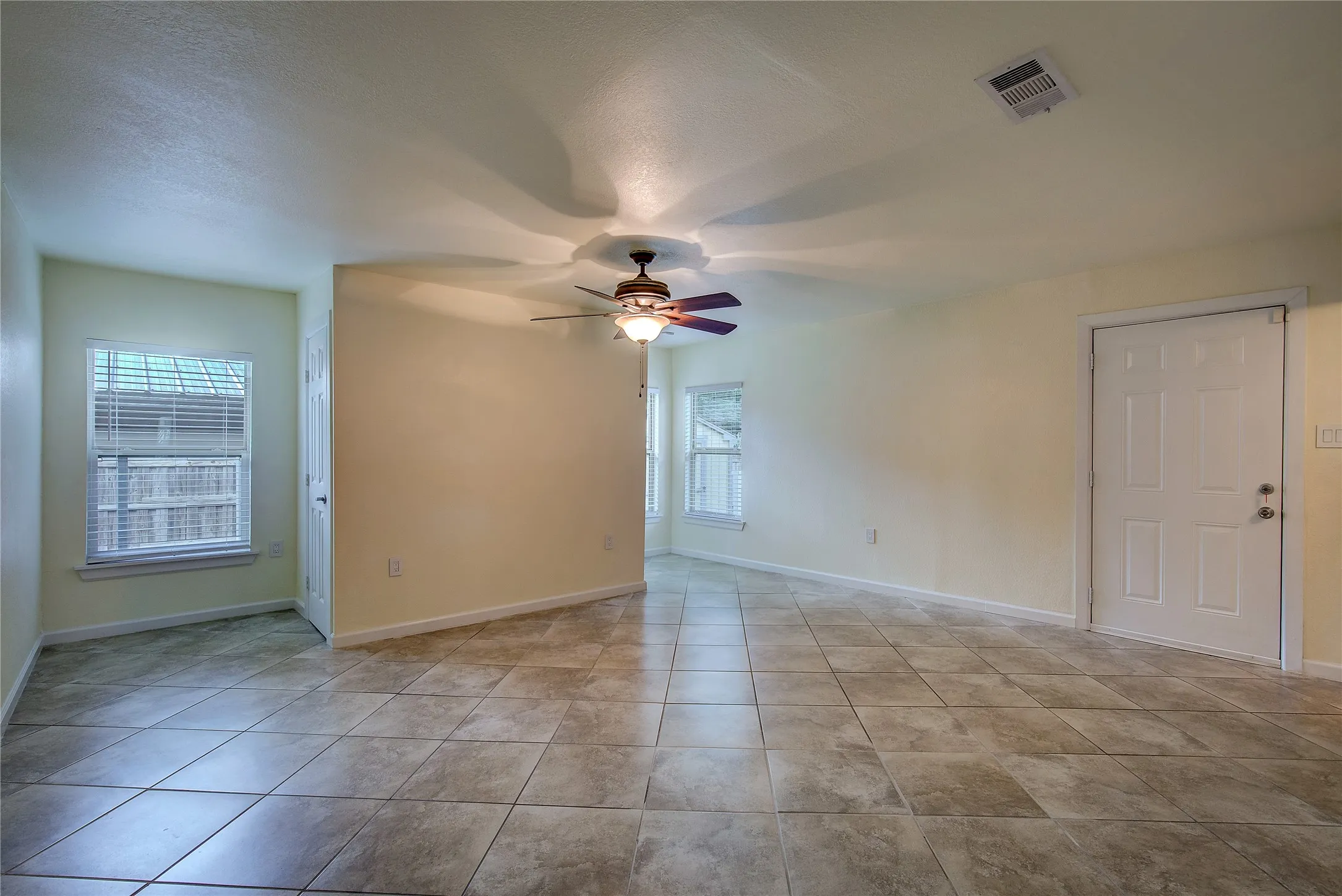 The primary suite also accesses the large backyard and wood deck.