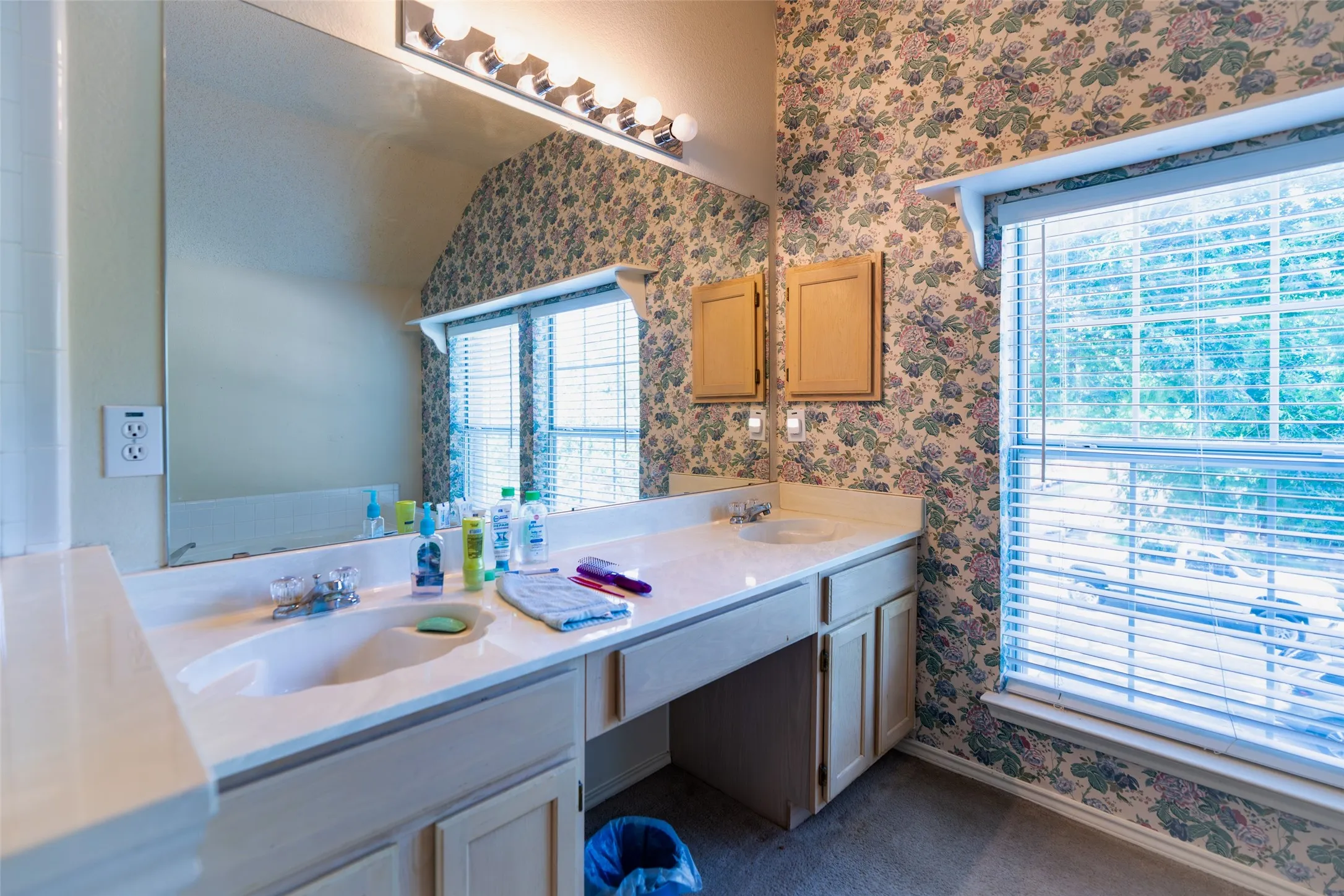Primary bath with dual vanities, dedicated makeup station and abundant natural light