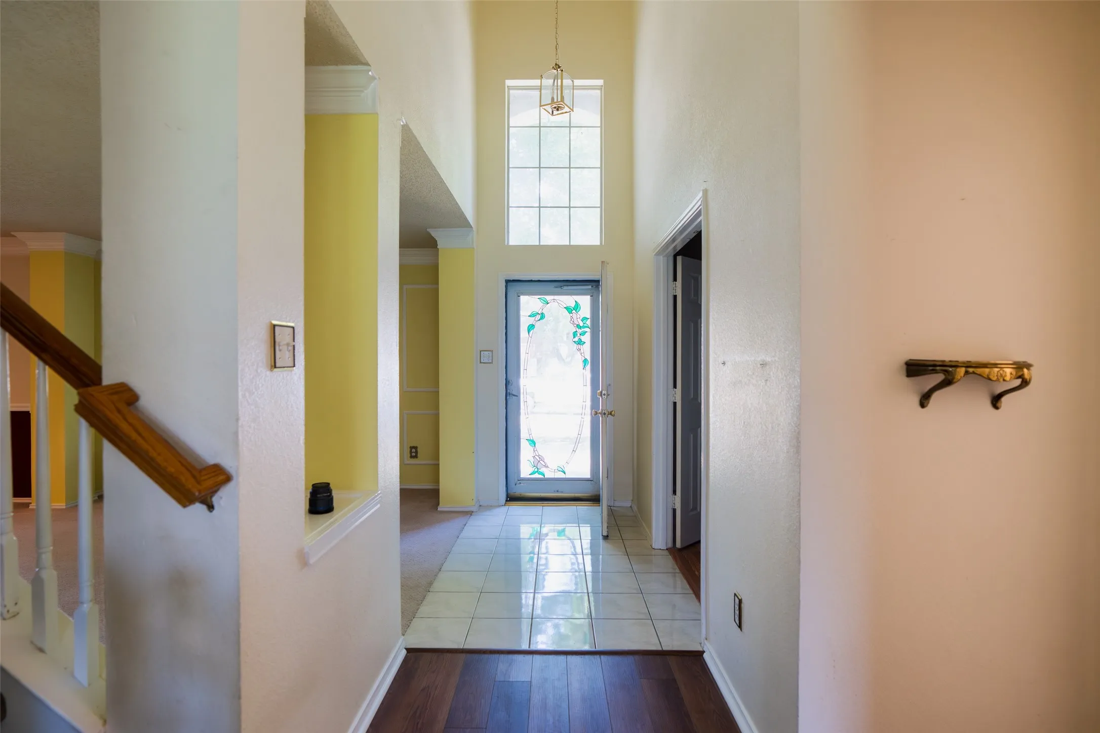 Inviting foyer showcases dramatic ceiling height and abundant natural light
