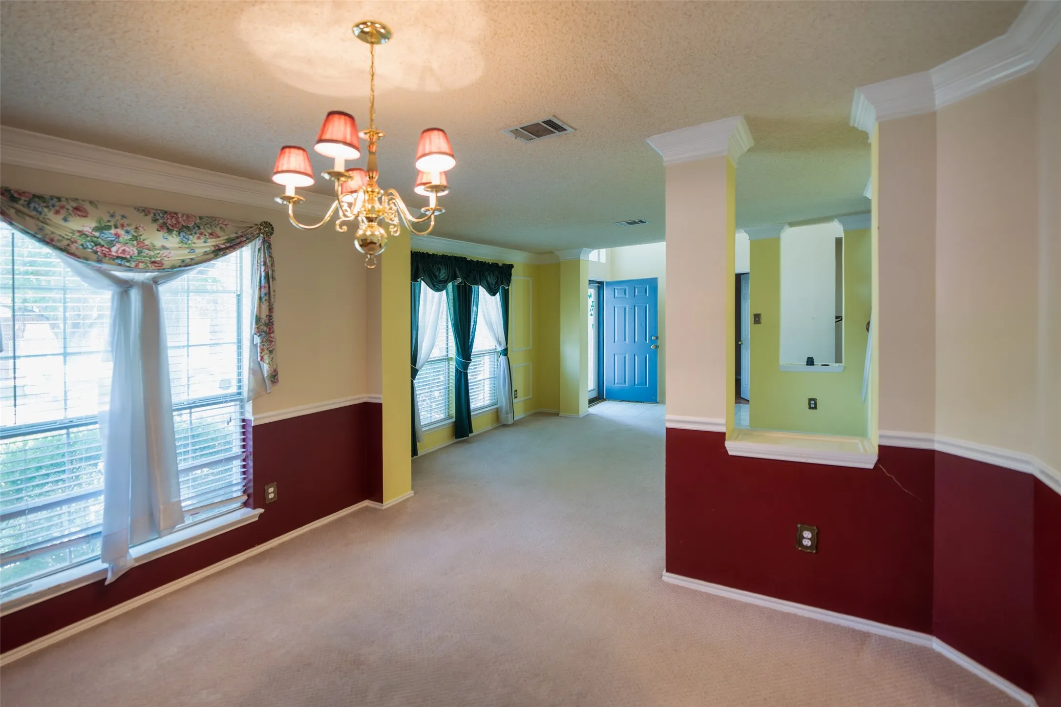 Open view from the formal dining room highlights the home's flowing floor plan and impressive two-story entry