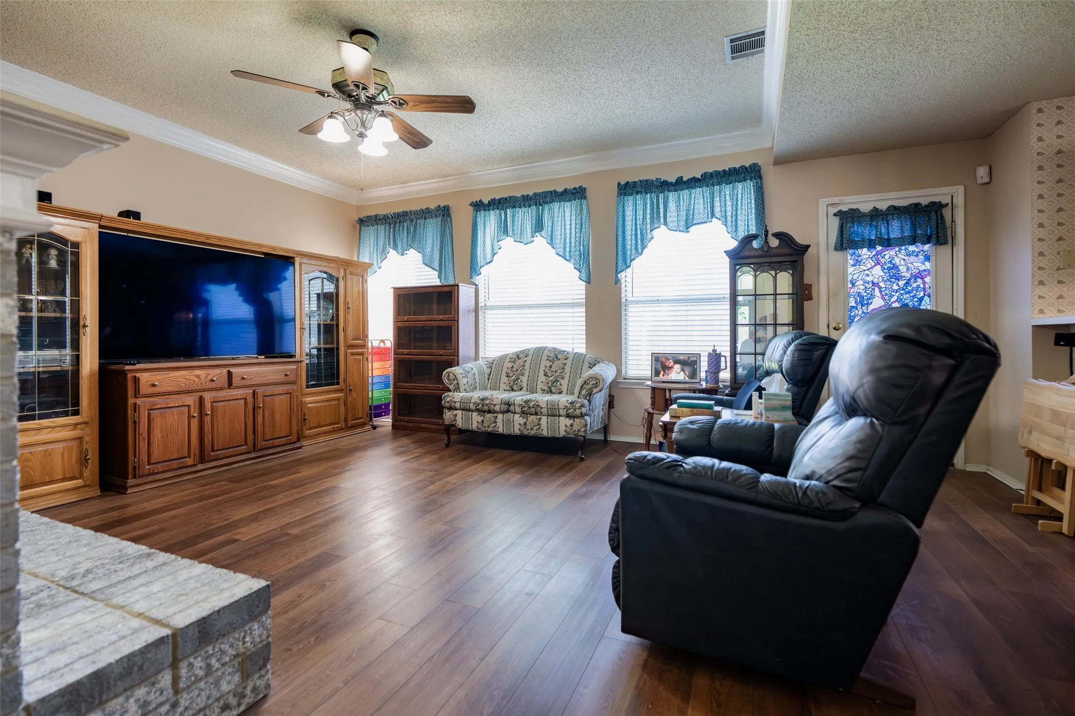 Family Room showcasing the wall of windows and open connection to the kitchen and breakfast area.