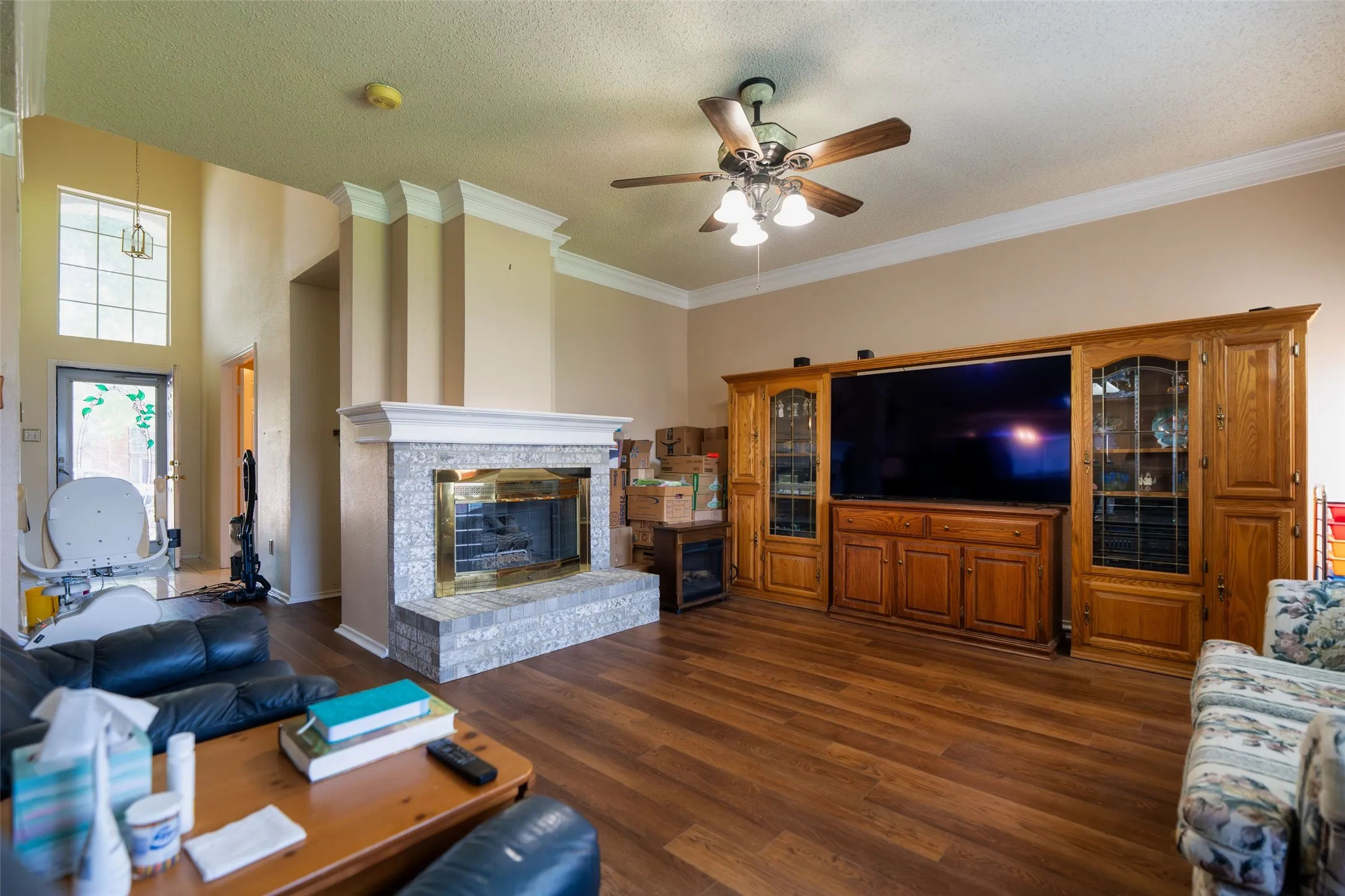 Family Room with impressive ceiling height, fireplace, and open sightlines to the two-story foyer.