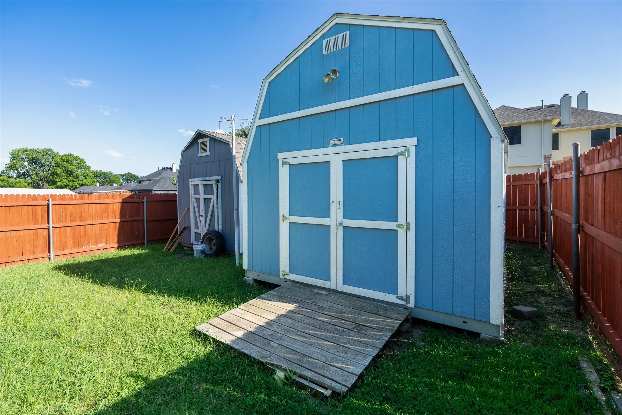 Two substantial storage buildings, including one workshop with electricity, provide exceptional space for projects, hobbies, tools, and organized storage