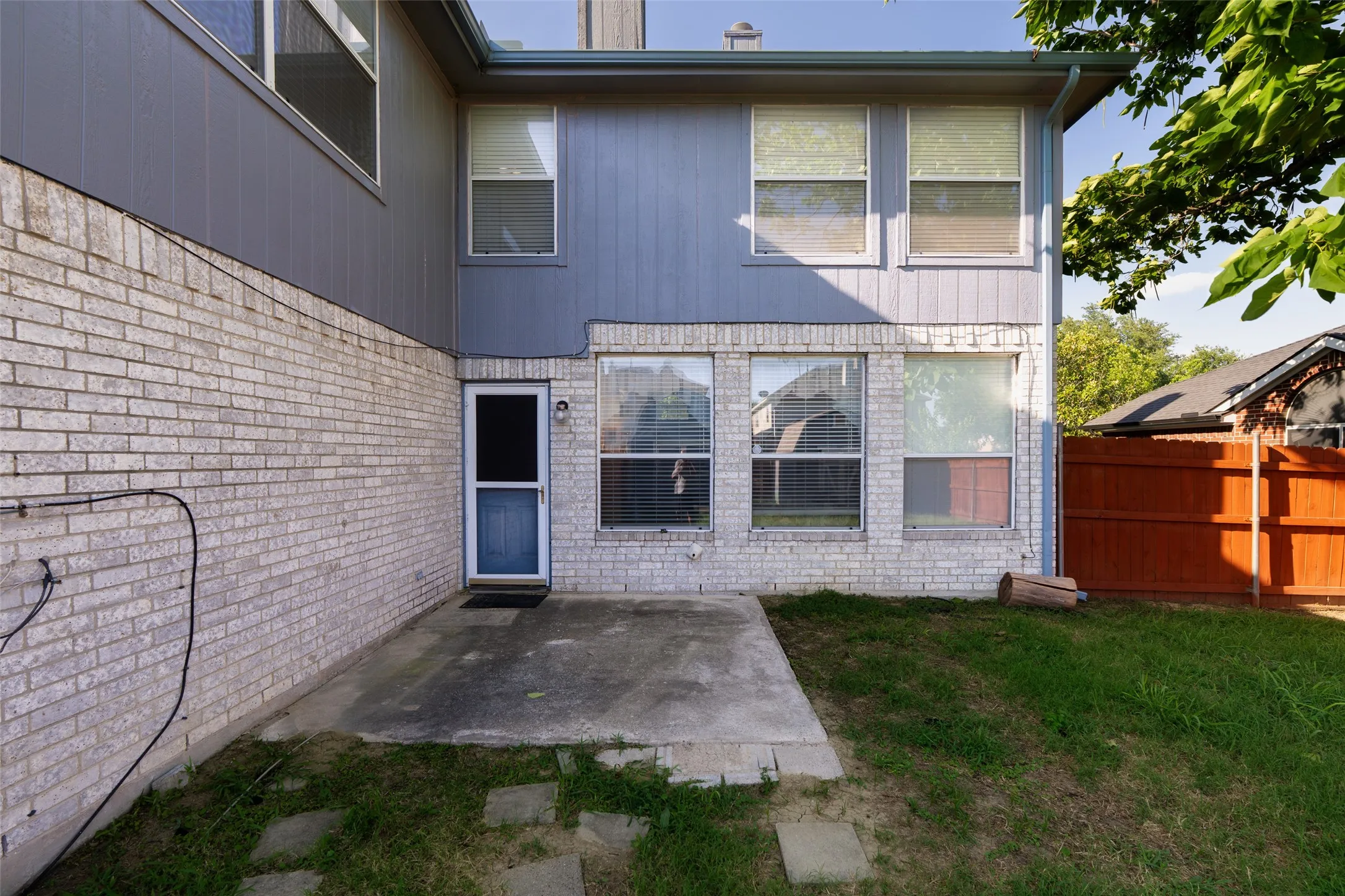 Private backyard patio overlooking the spacious, fenced yard
