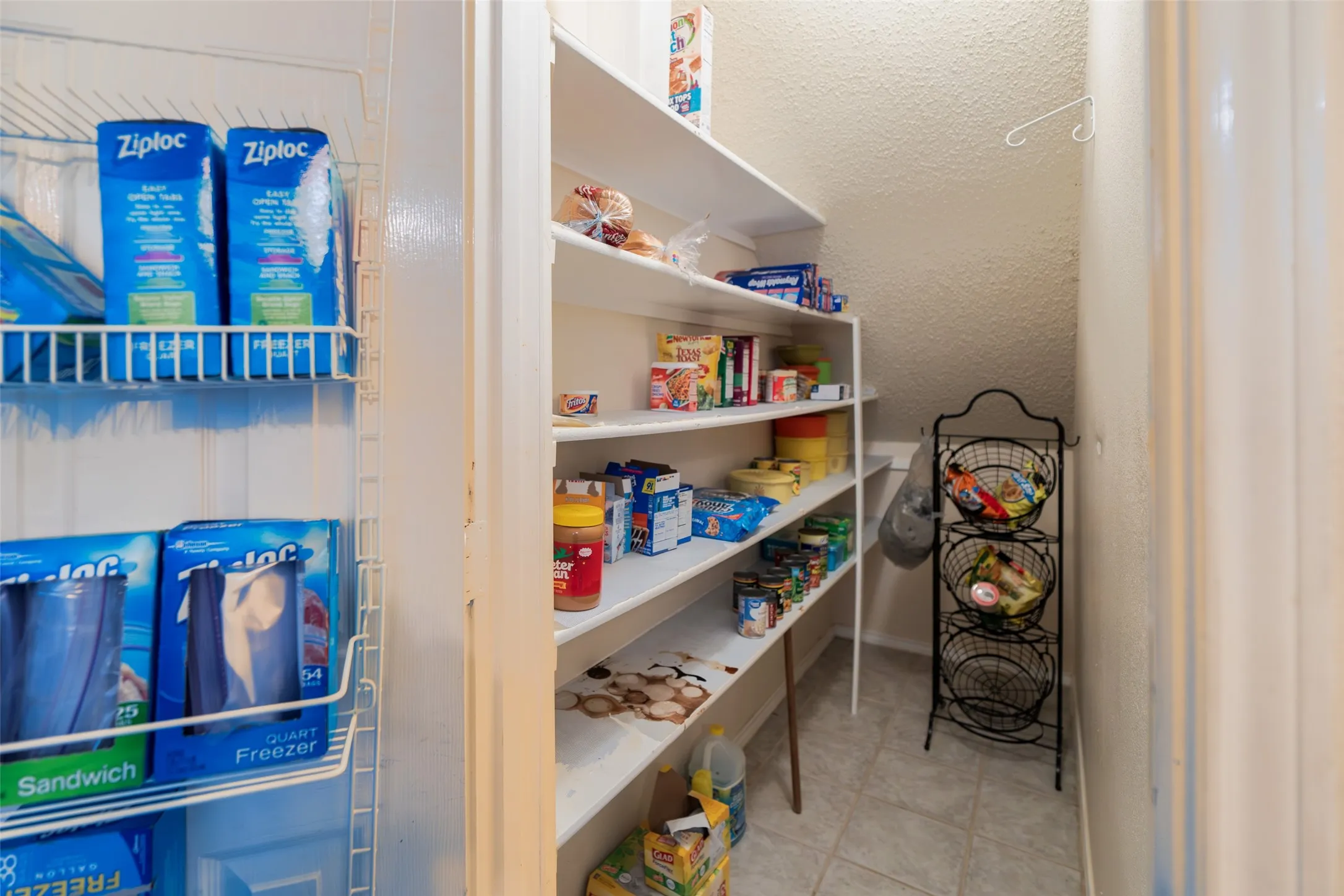 Large walk-in pantry provides abundant storage for food and kitchen essentials
