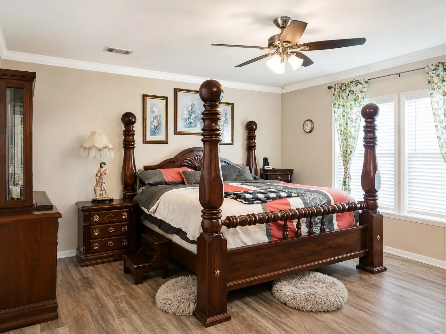 Spacious interior featuring wood-finish flooring, crown molding, and a ceiling fan with integrated lighting