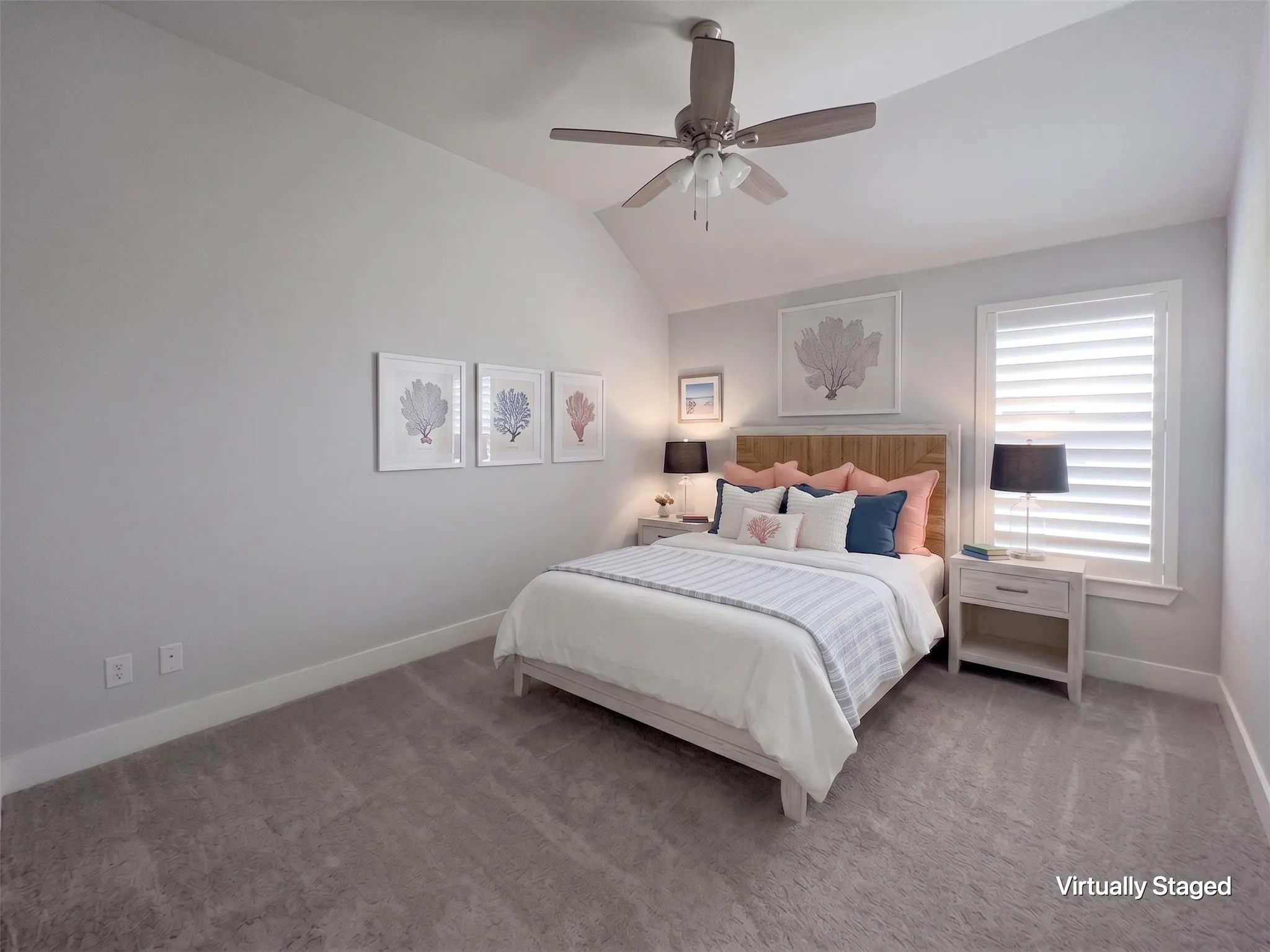Carpeted bedroom featuring a vaulted ceiling with a ceiling fan