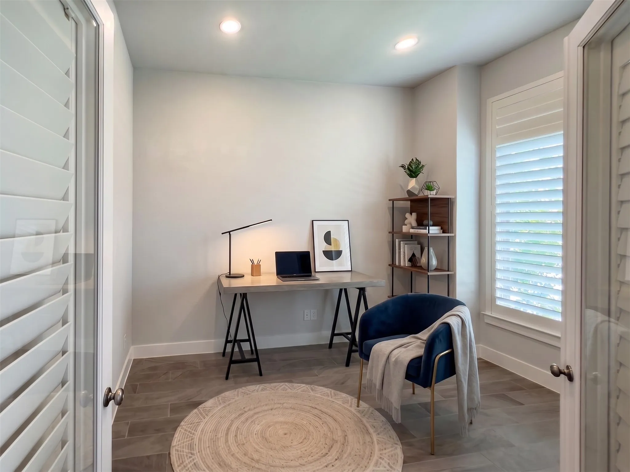 Bright room featuring recessed lighting and wood-finish flooring