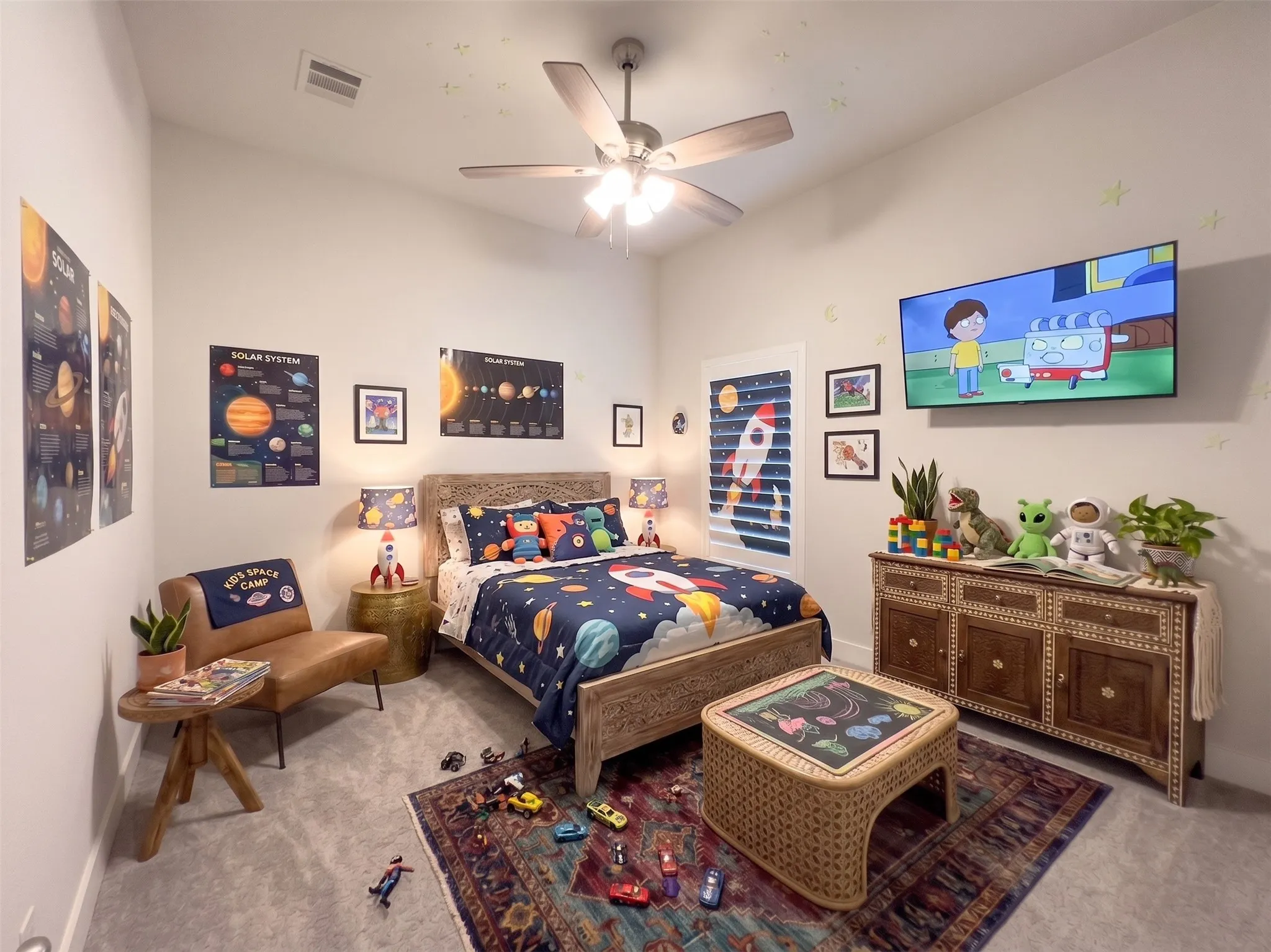 Carpeted room featuring a ceiling fan, a built-in wall-mounted television, and a decorative wood cabinet