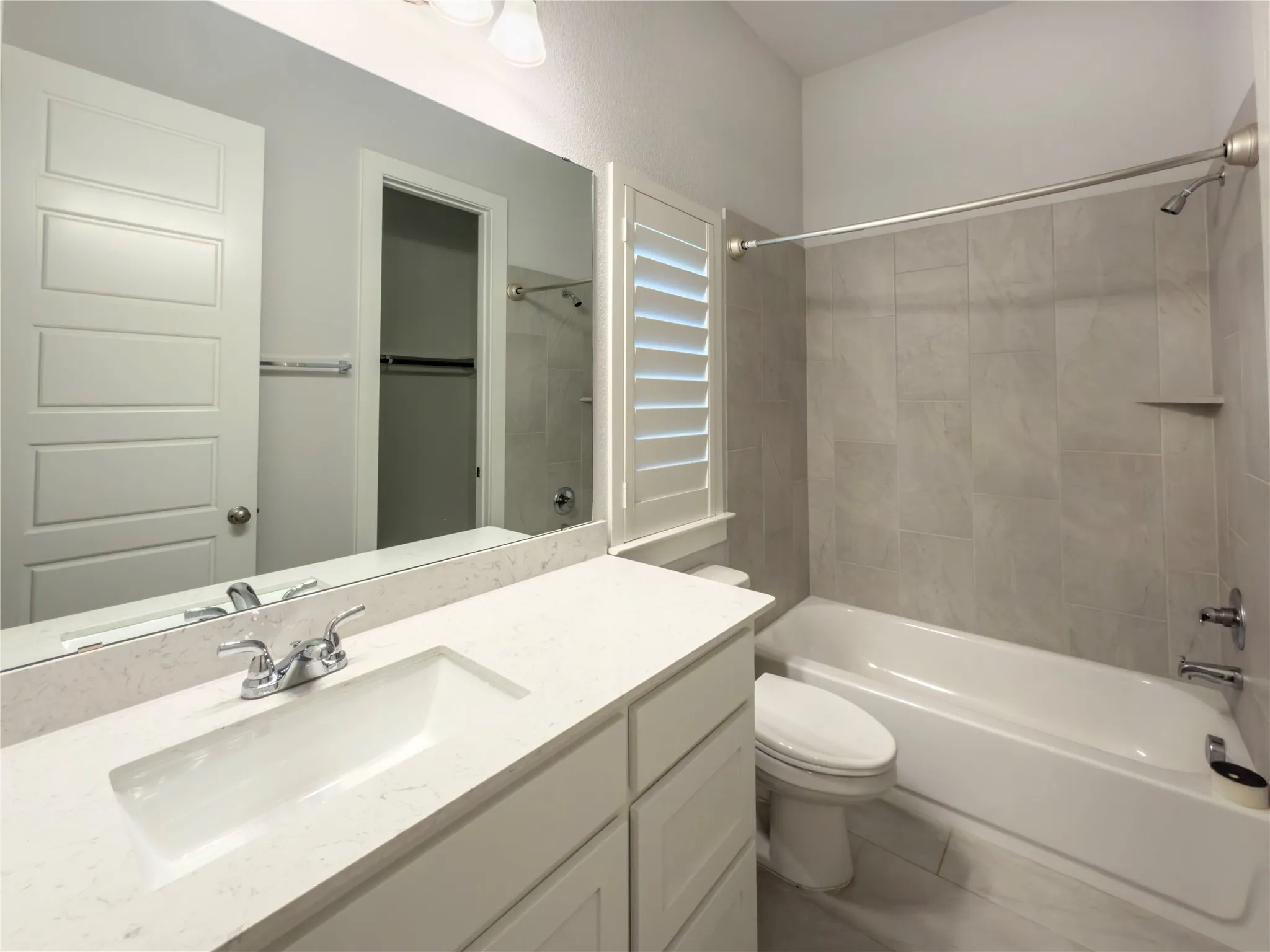 Bathroom featuring a vanity with an integrated sink and light-colored countertop