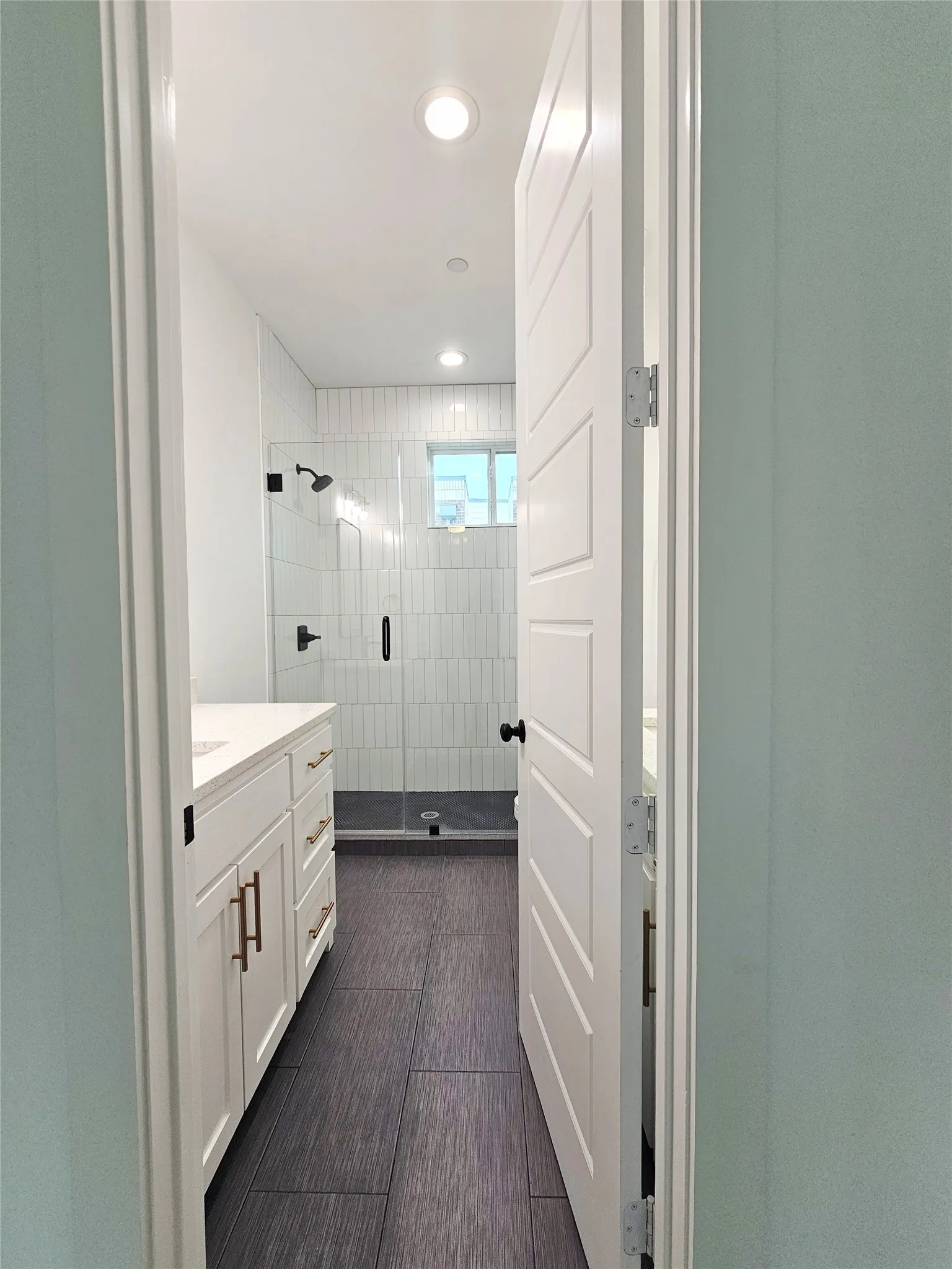 Bathroom featuring vanity, a shower stall, and recessed lighting