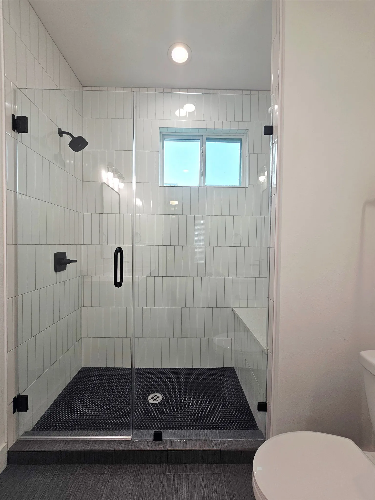 Full bath with toilet, a stall shower, and recessed lighting