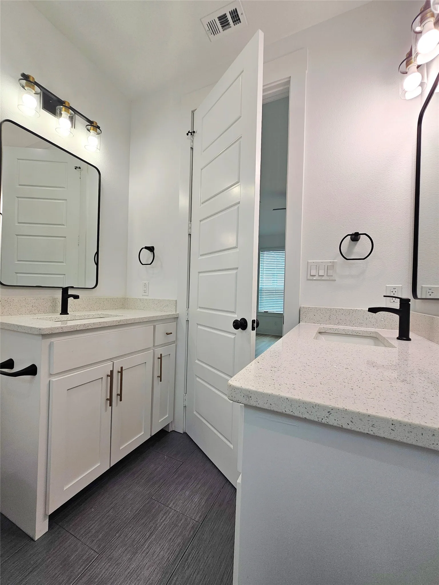 Bathroom featuring two vanities