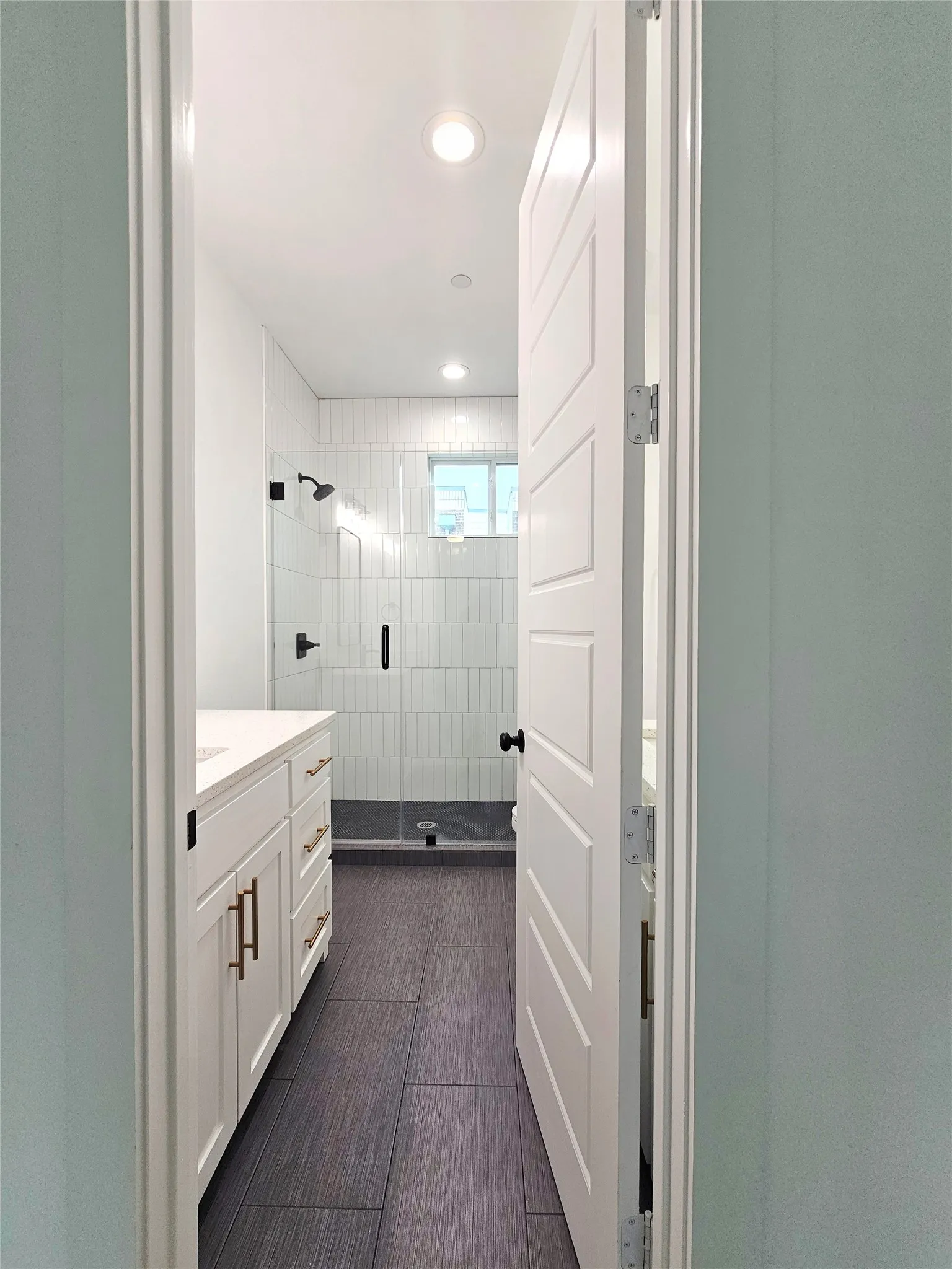 Bathroom featuring vanity, a stall shower, and recessed lighting