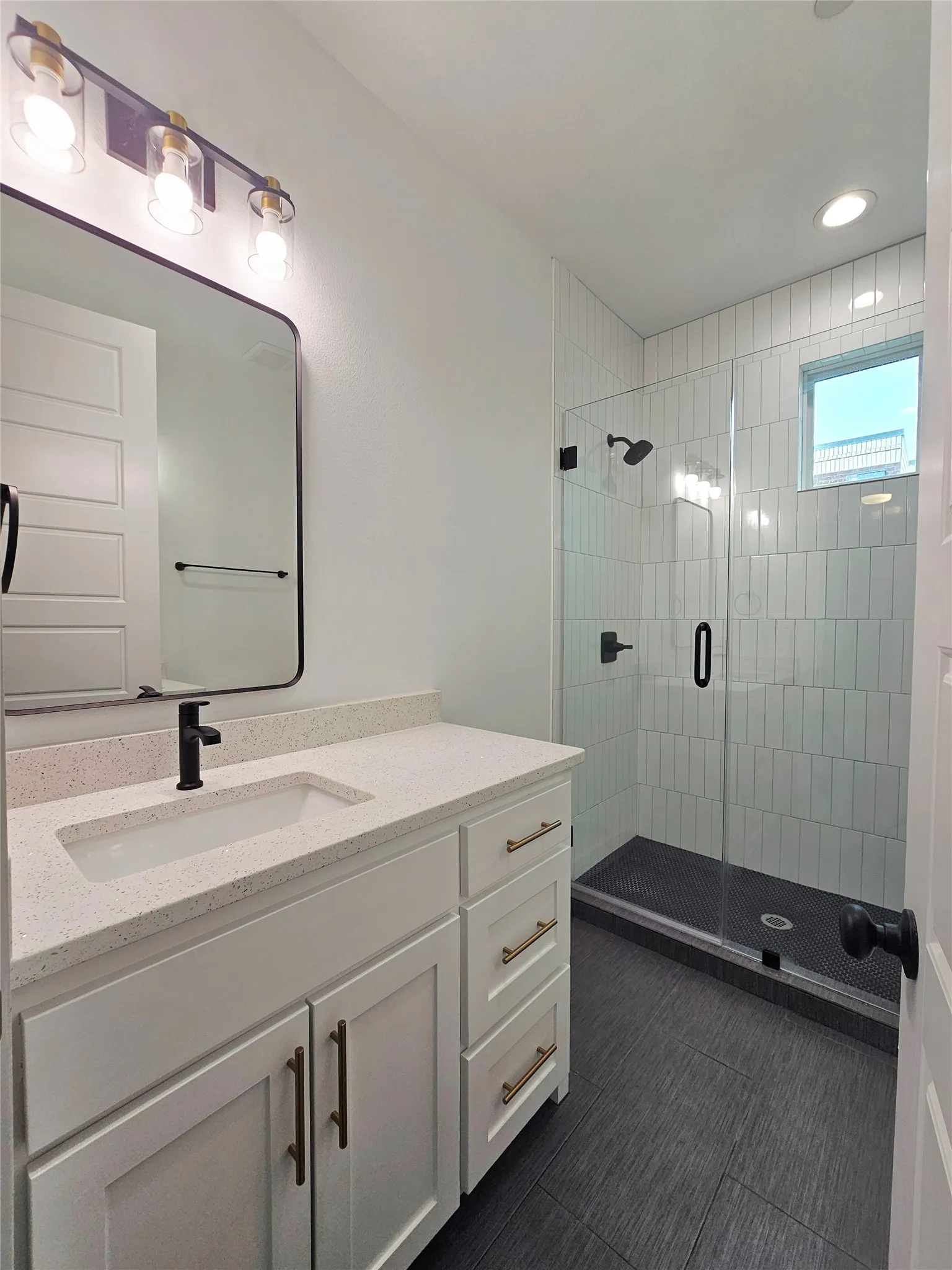 Full bath featuring a stall shower, vanity, and recessed lighting