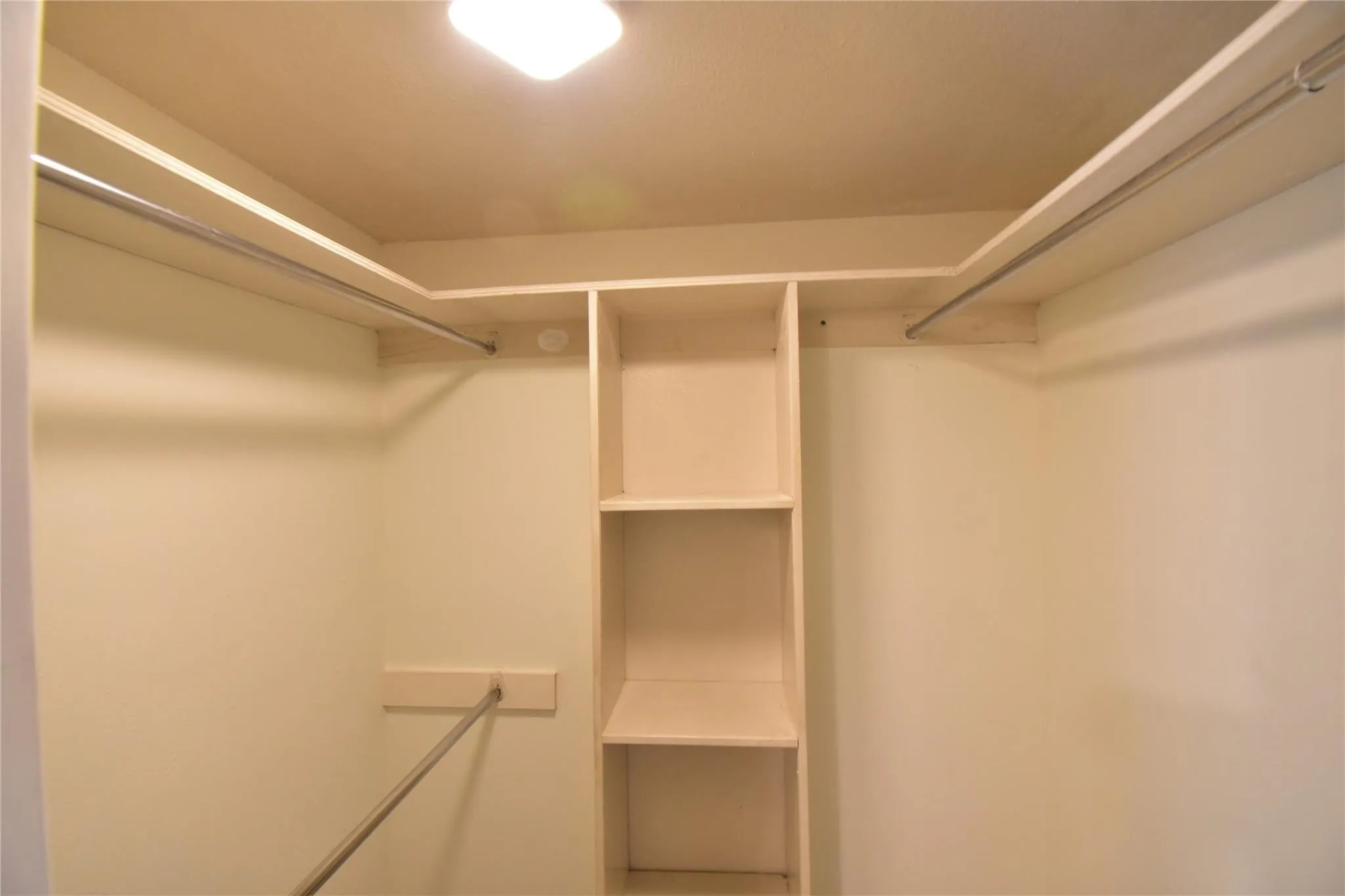 Master bedroom walk-in closet with motion sensor light