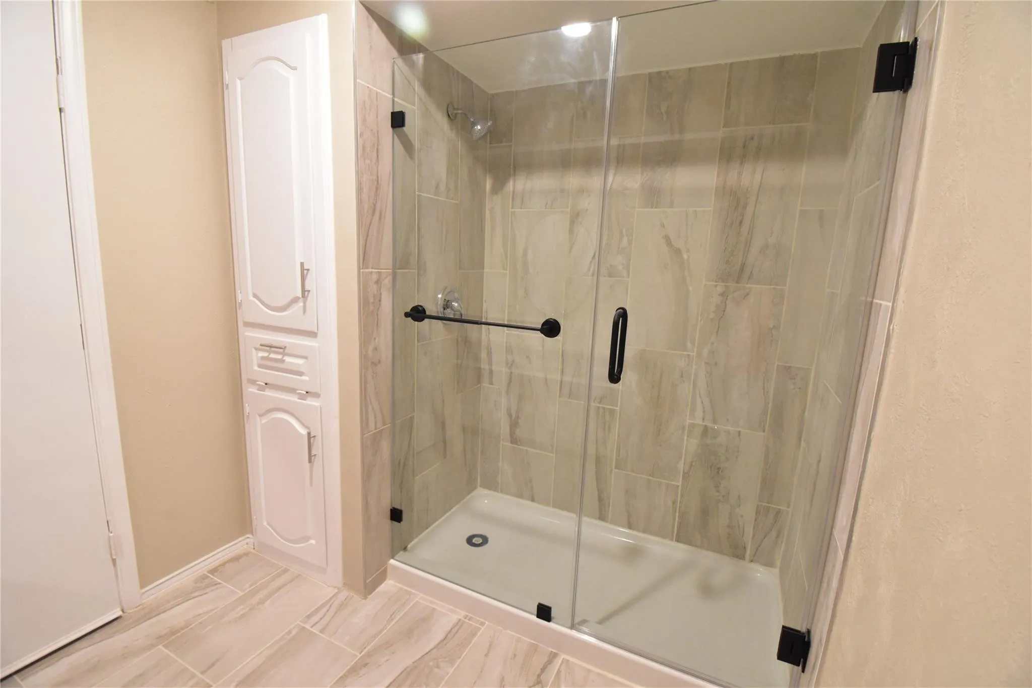 Master bathroom with 76” tall frameless shower enclosure