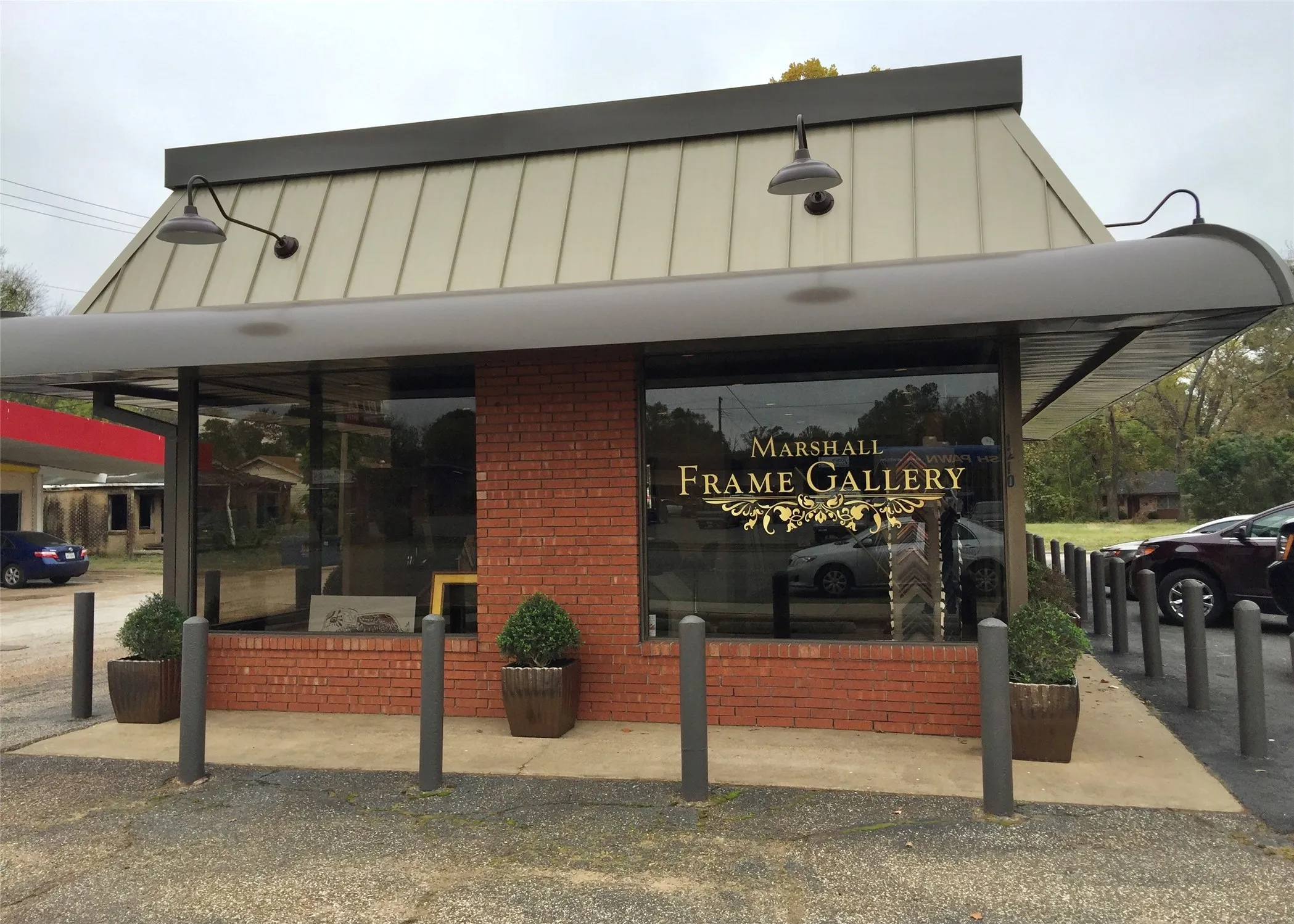 Commercial storefront featuring a brick facade and expansive display windows