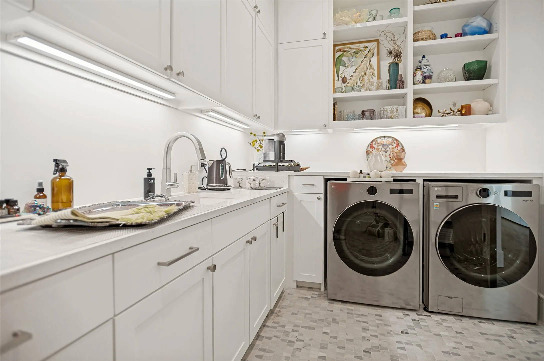 The laundry room with sink and cabinets to the ceiling. Lots of storage space