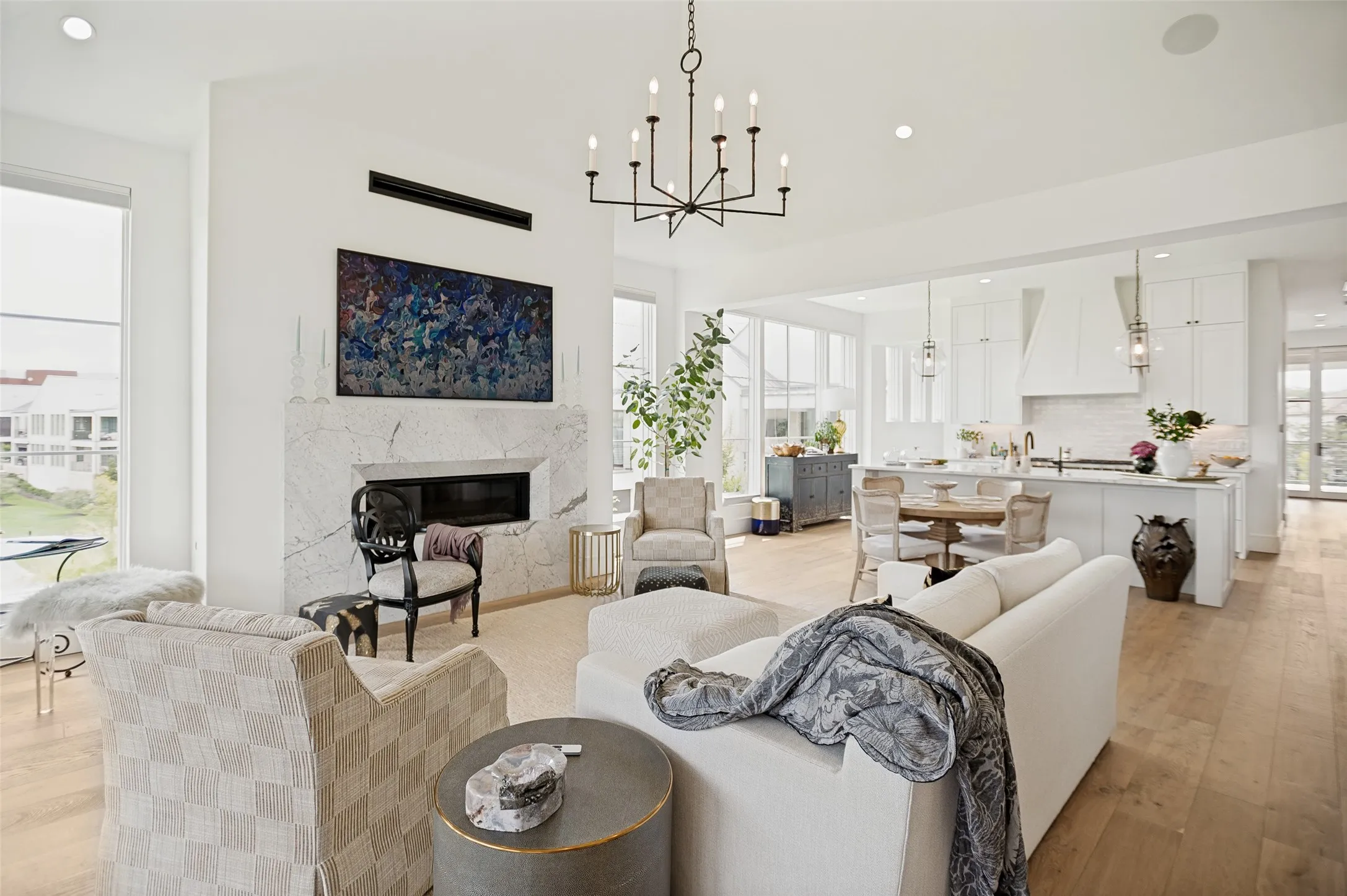 A striking marble fireplace serves as the centerpiece of the great room