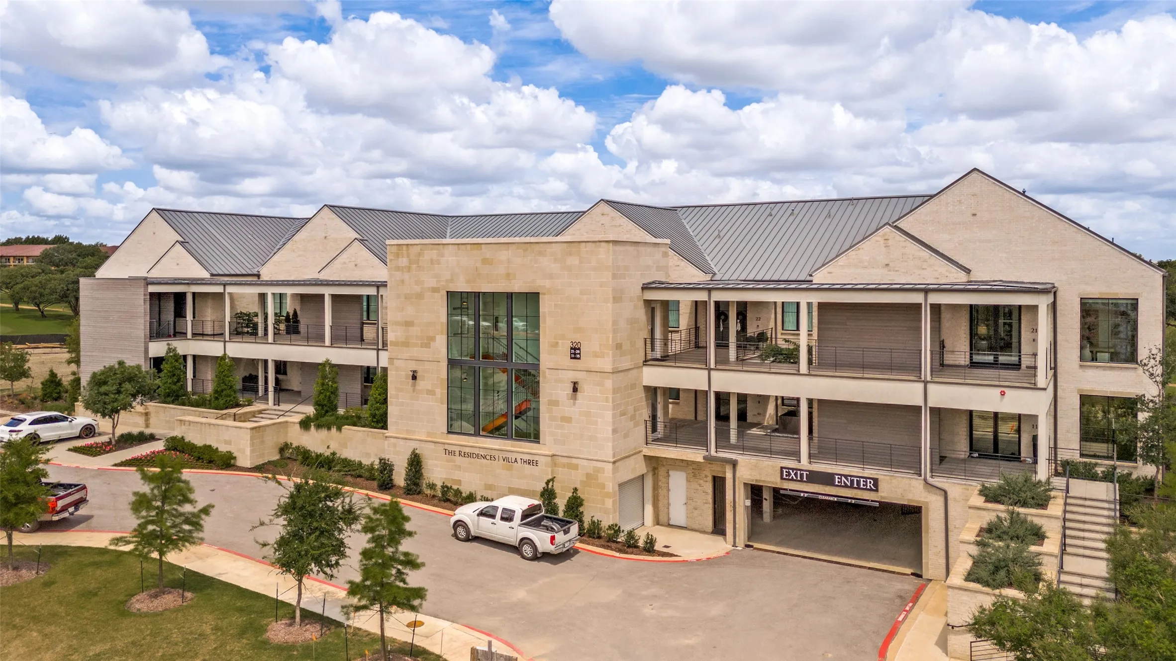 The striking exterior showcases a timeless blend of natural stone, clean architectural lines and a distinctive metal roof creating a modern design with enduring appeal