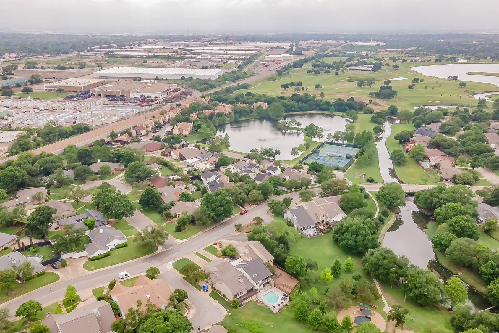 Aerial perspective showcasing a residential community with mature trees and a network of streets