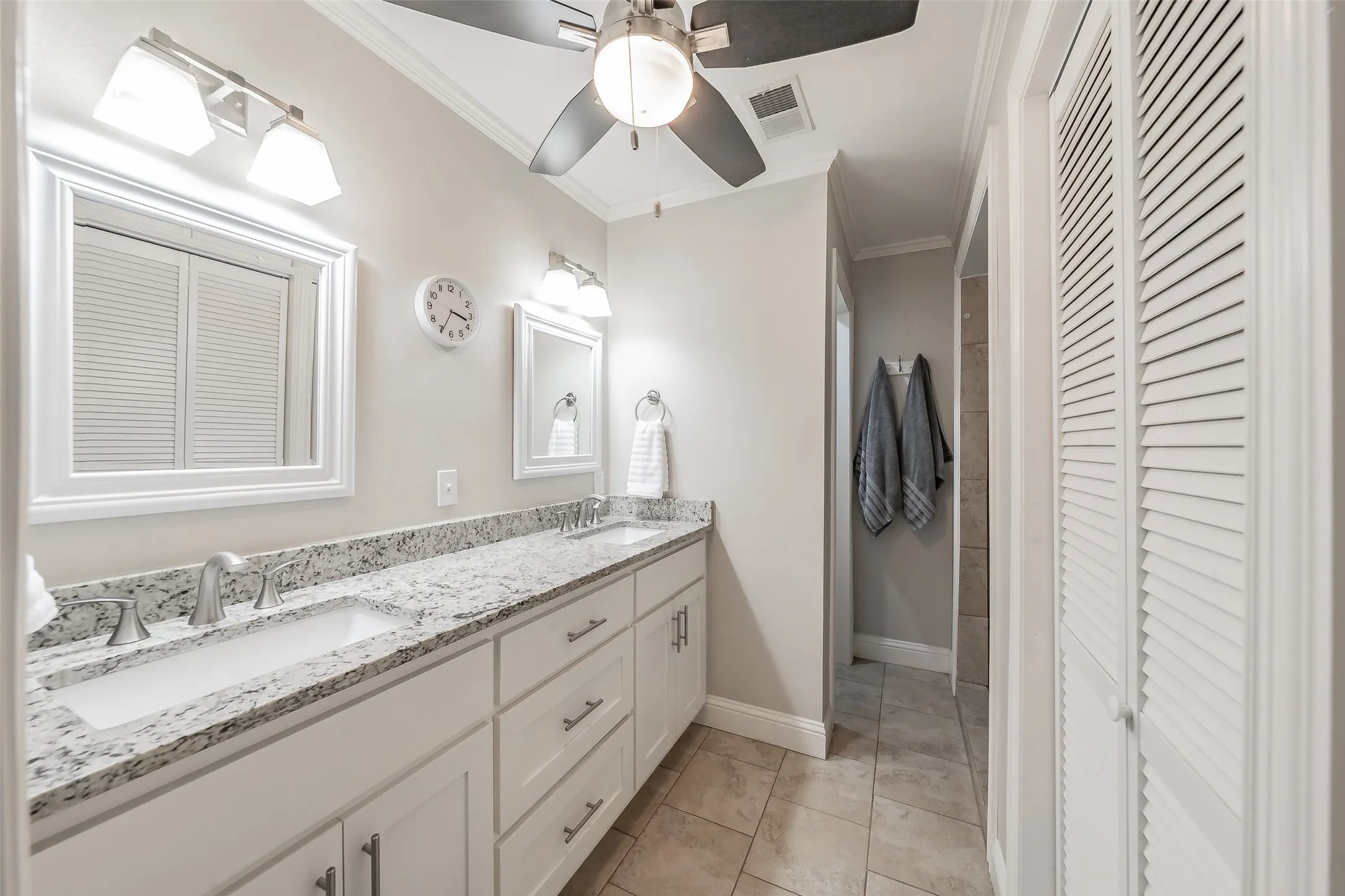 Double vanity with granite countertop, undermount sinks, and brushed nickel fixtures