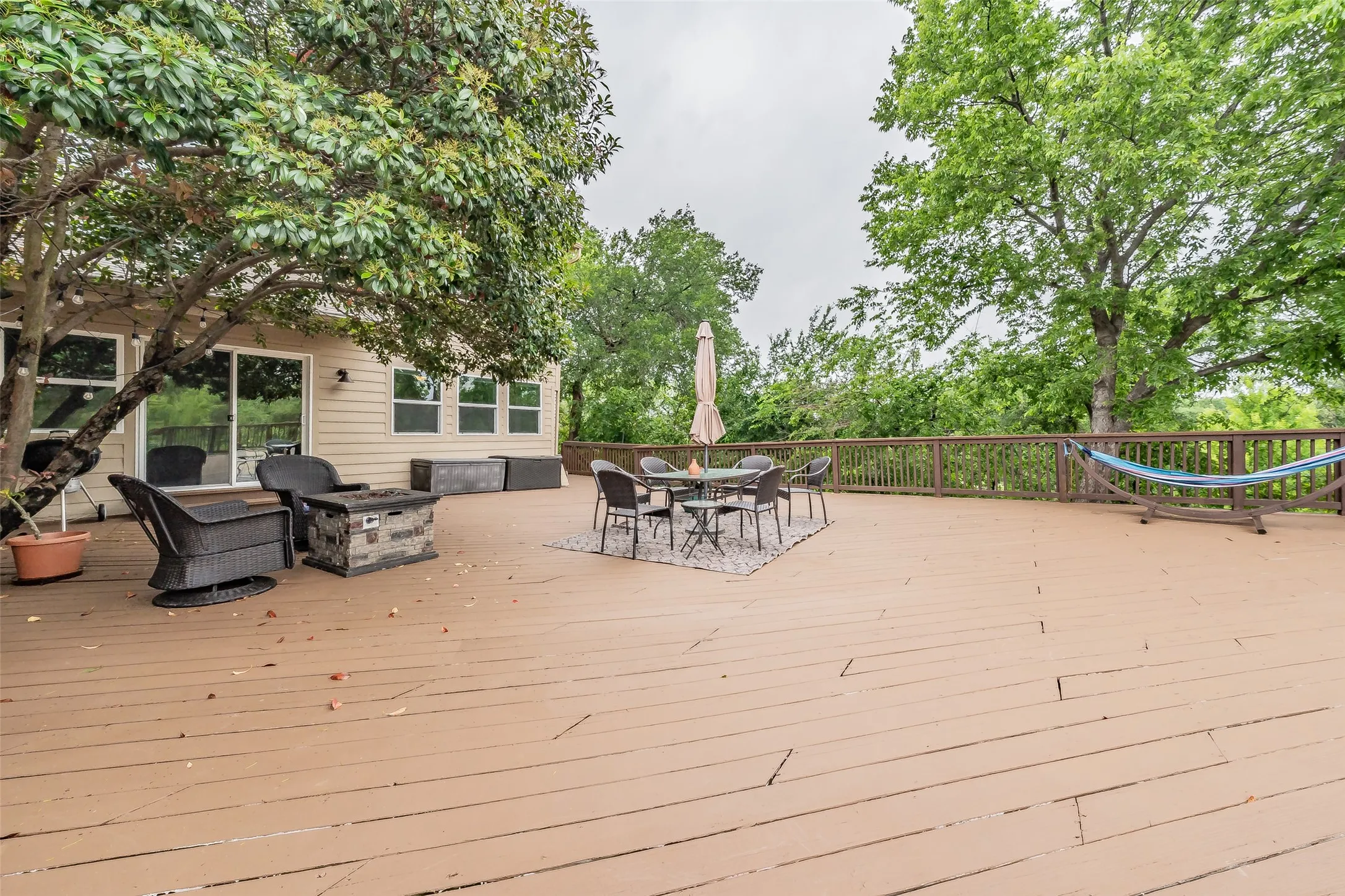 Expansive wood-finish deck with a wood railing