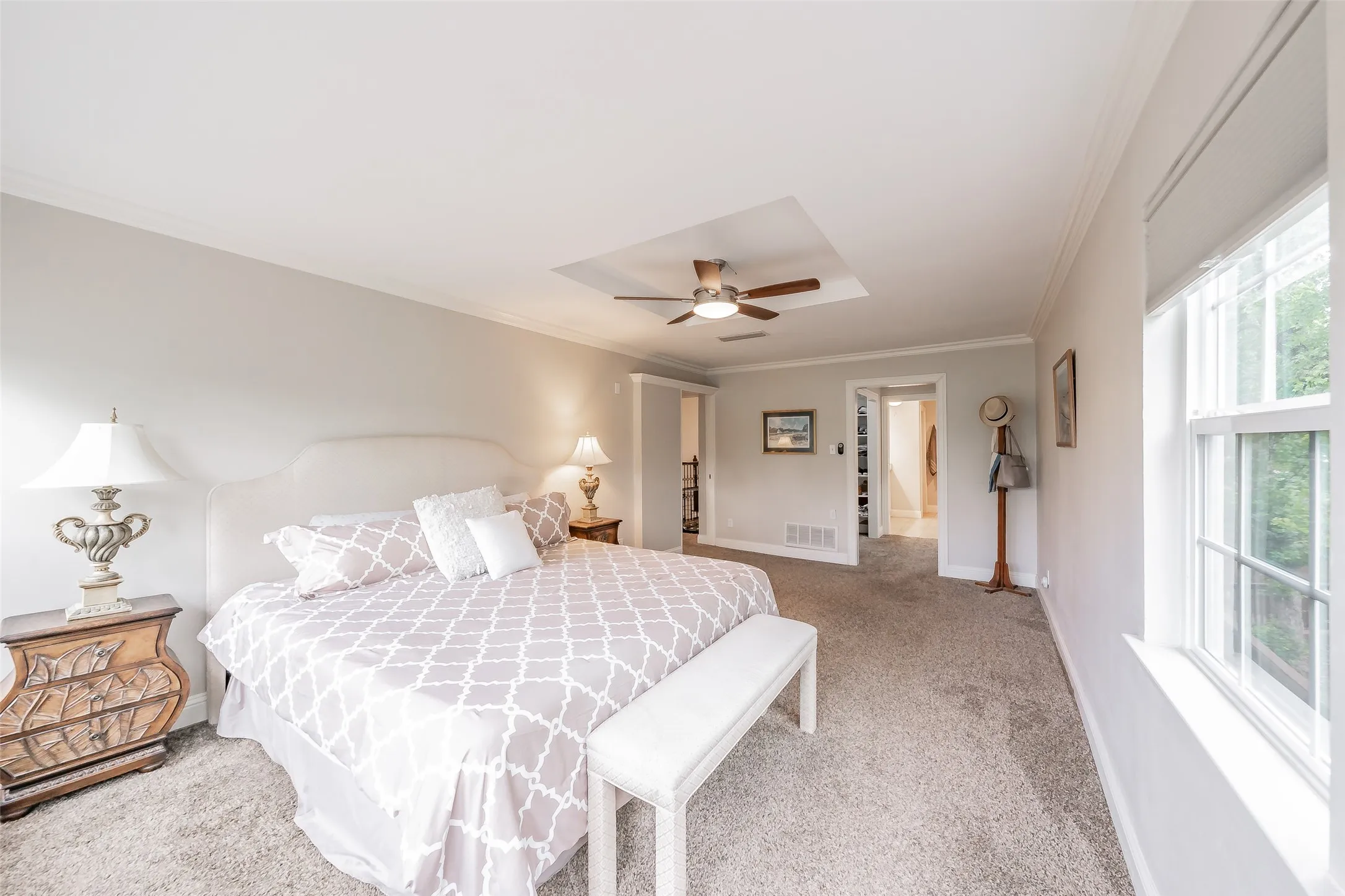 Spacious bedroom featuring light-toned walls, crown molding, and plush​​‌​​​​‌​​‌‌​‌‌​​​‌‌​‌​‌​‌​​​‌​​ carpeting