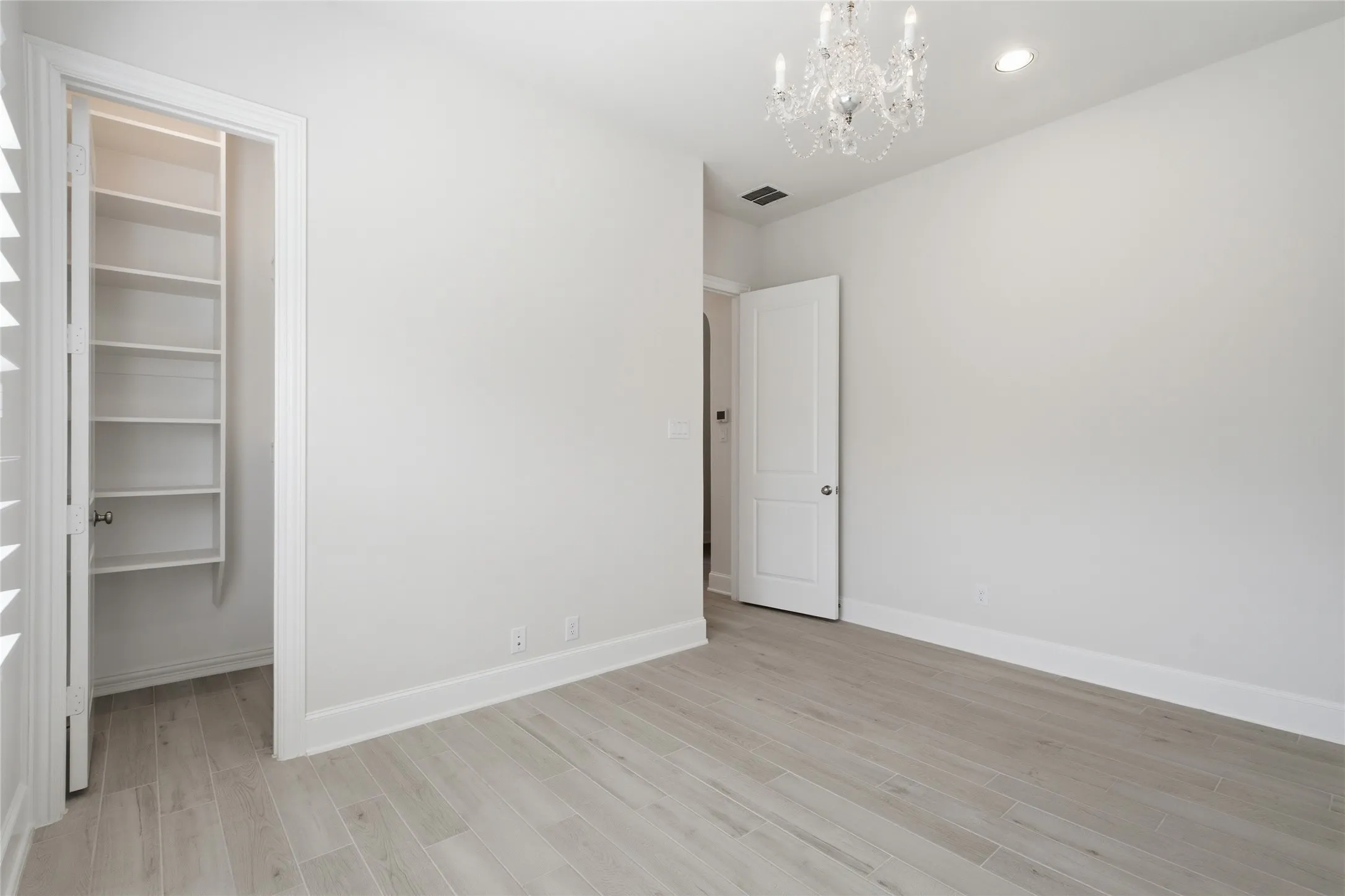 Secondary Bedroom With WIC, Chandelier And Recessed Lighting.