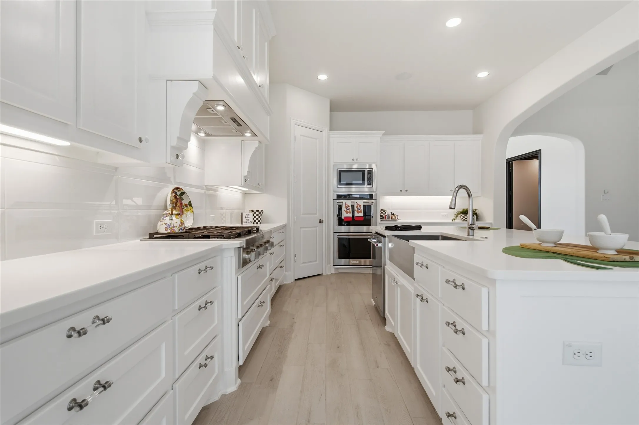 Culinary Center Features Large Prep Areas, Quartz Countertop, Double Ovens, Microwave, And Under And Upper Cabinet Lighting.
