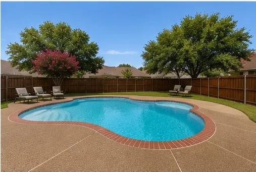 Curved swimming pool with a brick coping, surrounded by a stamped concrete deck and a manicured lawn. Virtually staged