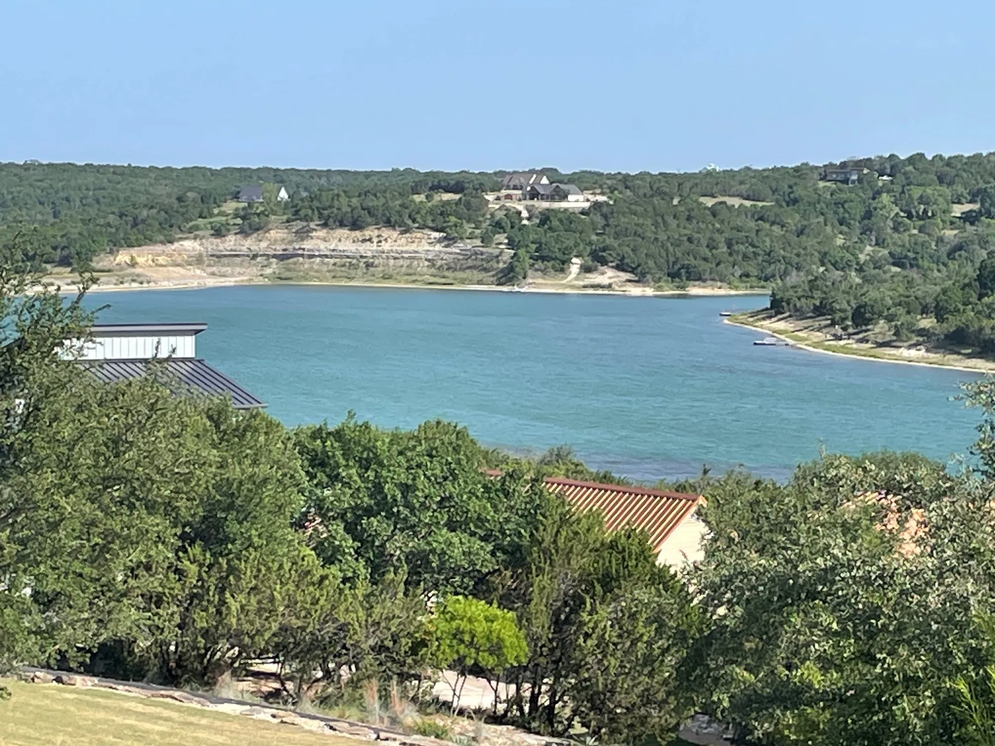 Expansive water body surrounded by natural landscape