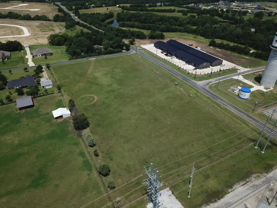 The property is surrounded by residential, commercial, and farm-and-ranch acreage.