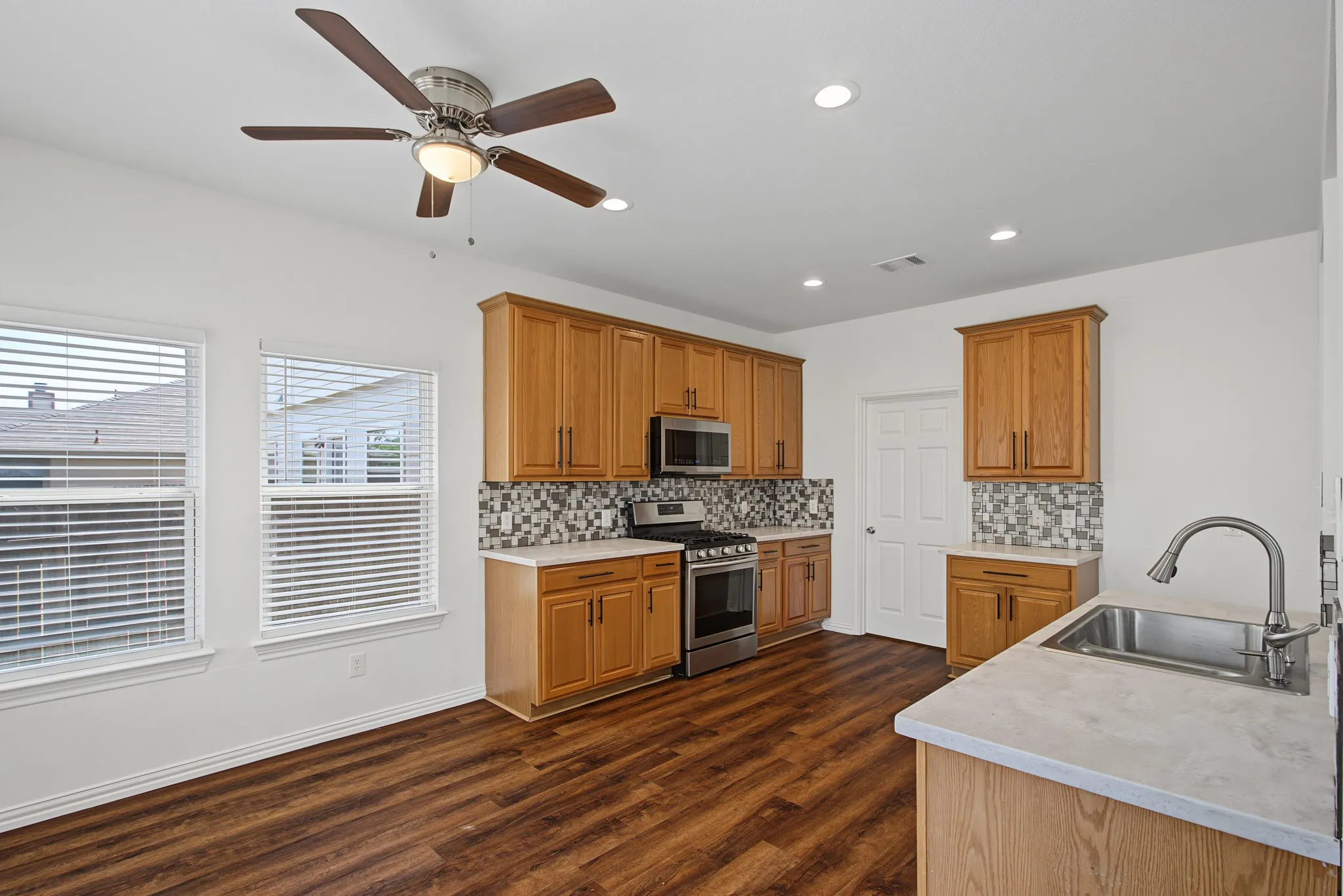 Kitchen featuring wood-finish flooring, recessed lighting, and a ceiling fan