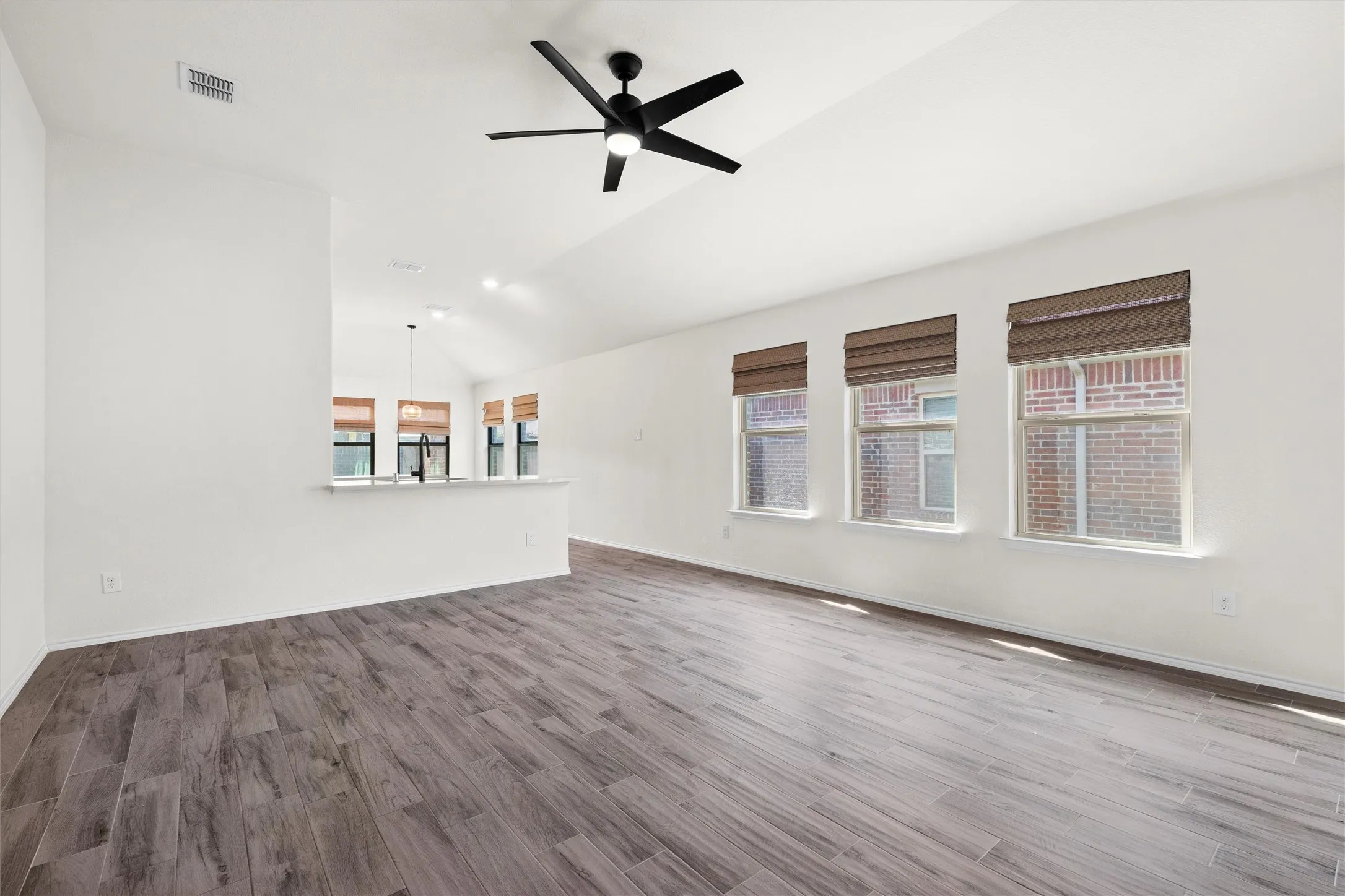 This massive, sun-drenched living area is an absolute dream for entertaining or family movie nights. Vaulted ceilings paired with a sleek, matte black ceiling fan keep things feeling airy and cool. Plus, check out those three massive windows letting in all that gorgeous Texas sunshine! ??.  #OpenConcept #LivingRoomGoals #BrightSpaces #FamilyHome #NorthTexasRentals
