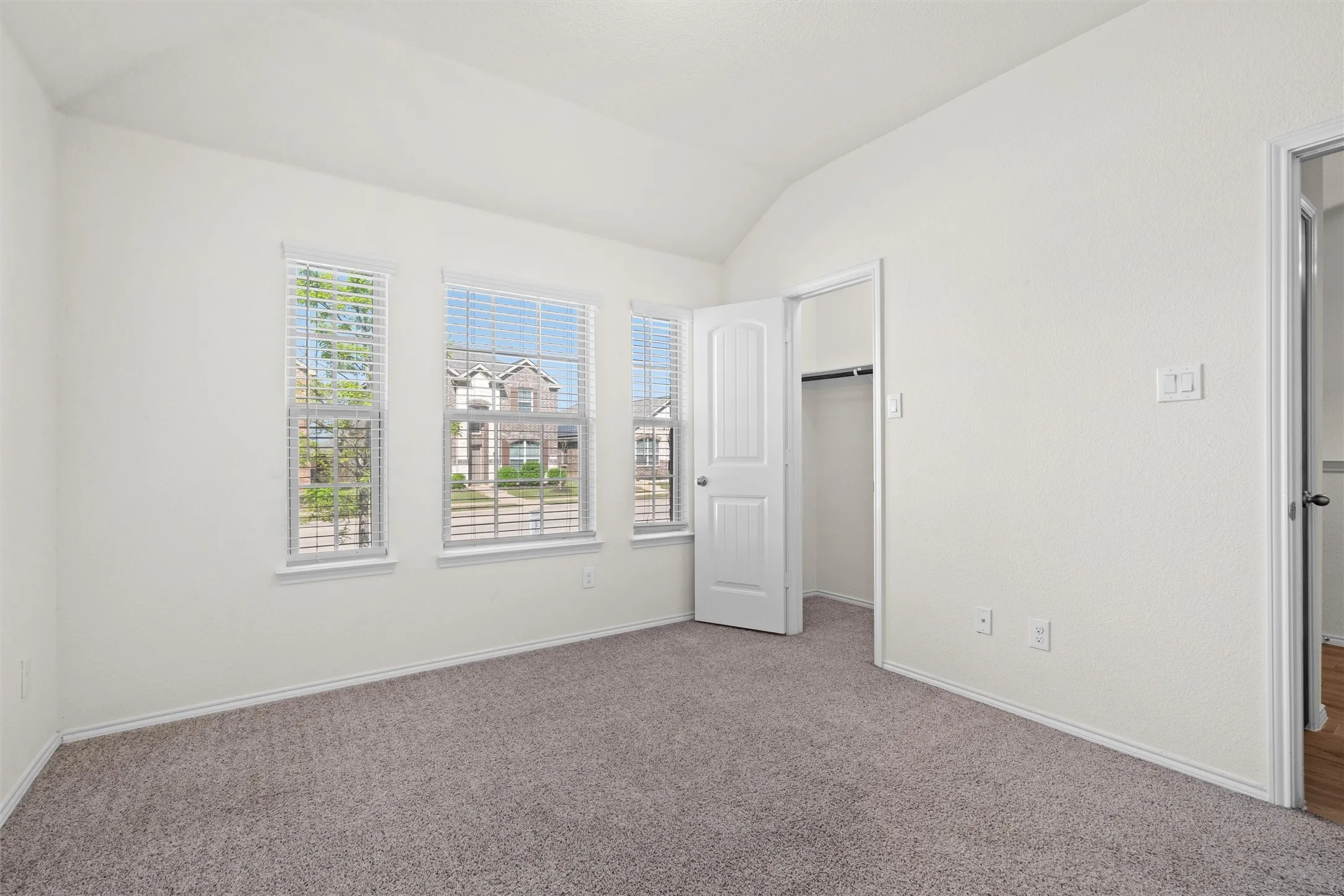 Unwind in style. The spacious primary suite features a beautiful vaulted ceiling, plush neutral carpeting, and a trio of windows looking out to the neighborhood. Bonus: It comes complete with a massive walk-in closet for all your storage needs!
Tags: #MasterBedroom #PrimarySuite #CozyVibes #WalkInCloset #BedroomGoals