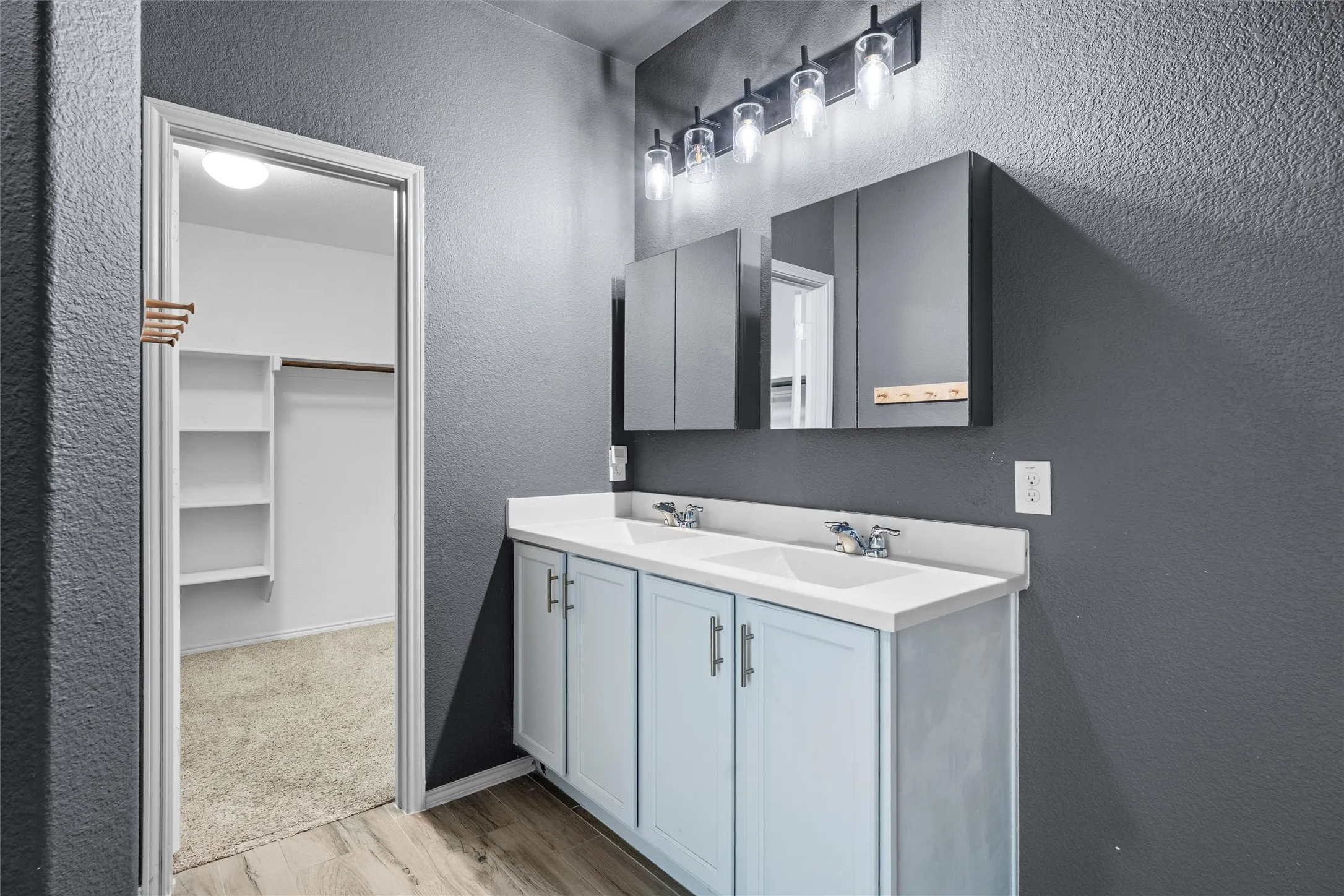 Say goodbye to sharing sink space! This gorgeous primary bathroom features a double vanity with plenty of sleek counter space and contemporary light-blue cabinetry accented by modern hardware. Complete with dual matching medicine cabinets for extra storage and dramatic, dark accent walls that create a sophisticated spa-like atmosphere.
Tags: #DoubleVanity #BathroomGoals #SpaBathroom #ModernDesign #LuxuryLook