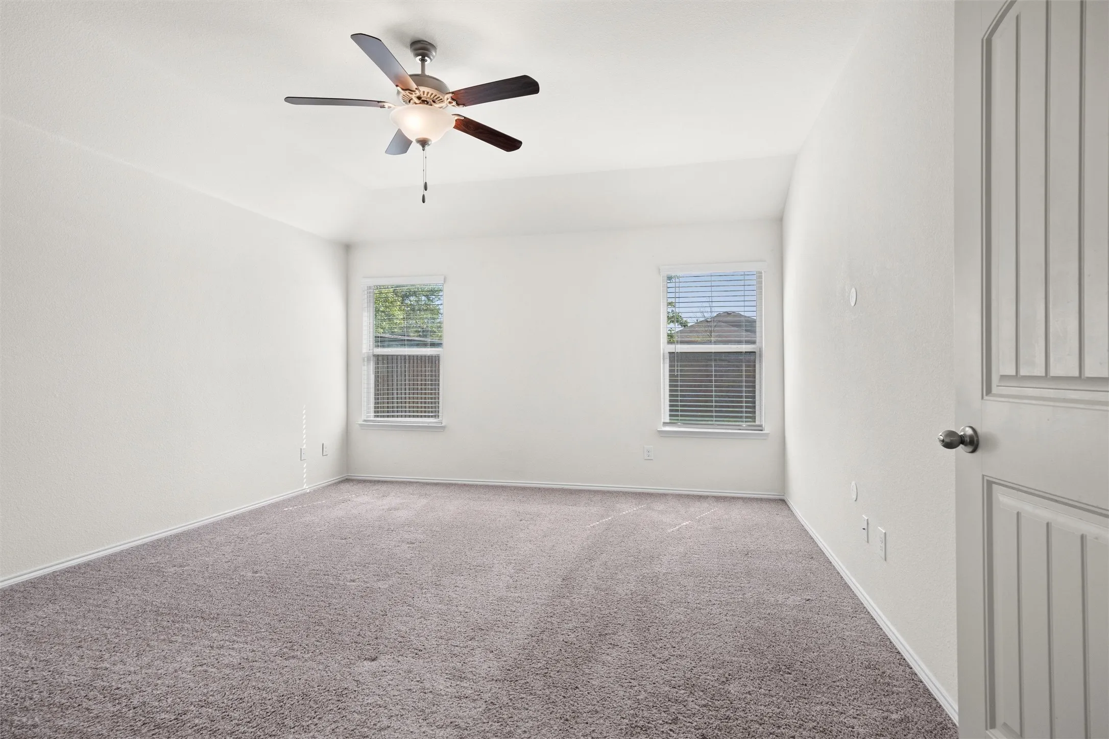 Another look at this expansive primary retreat! High vaulted ceilings and dual windows bring in a beautiful wash of natural light, emphasizing just how much space you have for a king-sized bed and a full bedroom set. Finished with fresh neutral paint and plush, immaculate carpeting underfoot.
Tags: #PrimaryBedroom #MasterSuite #TexasRealEstate #SpaciousLiving #MoveInReady