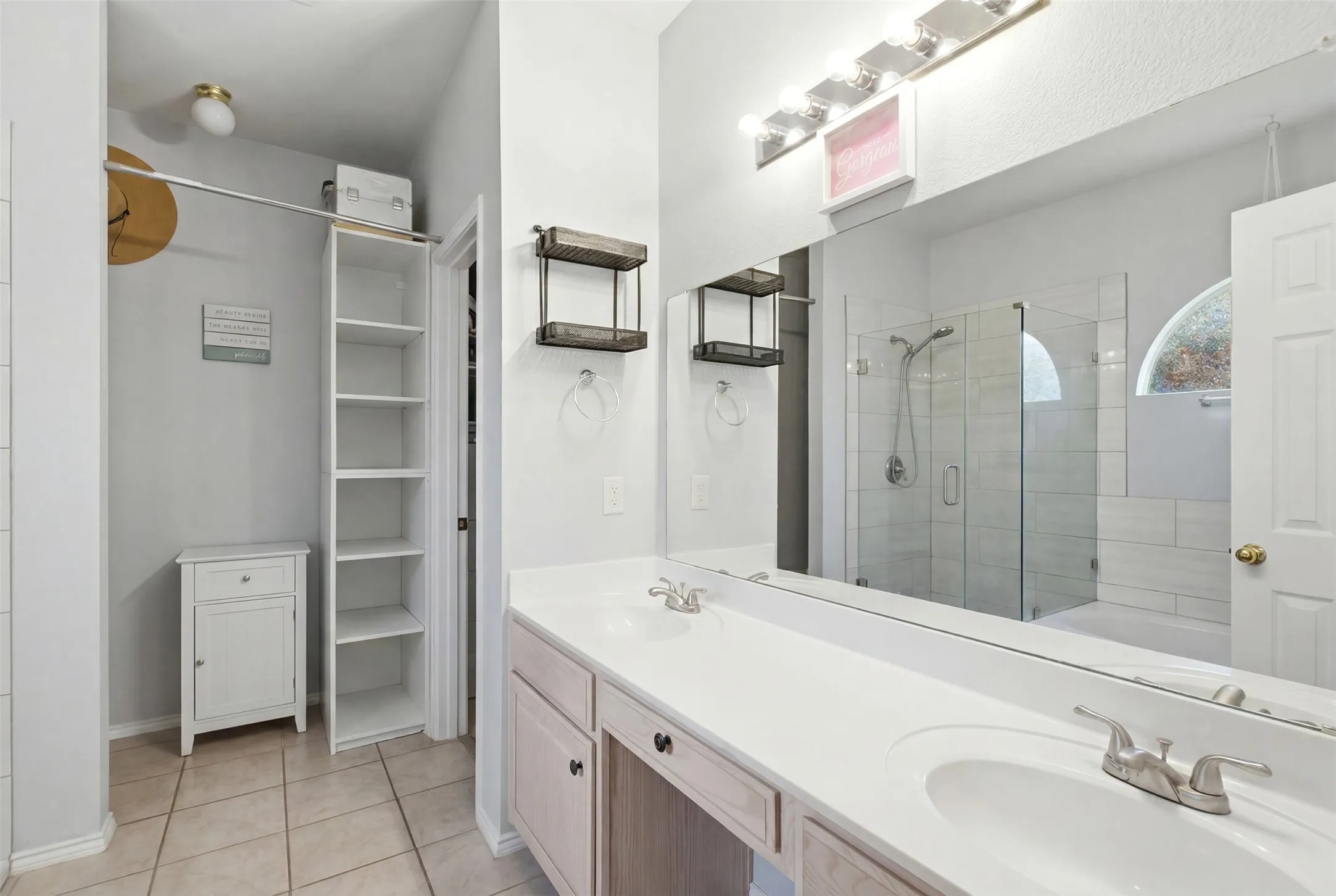 Dual vanity with integrated sinks, brushed nickel fixtures, and extensive countertop space