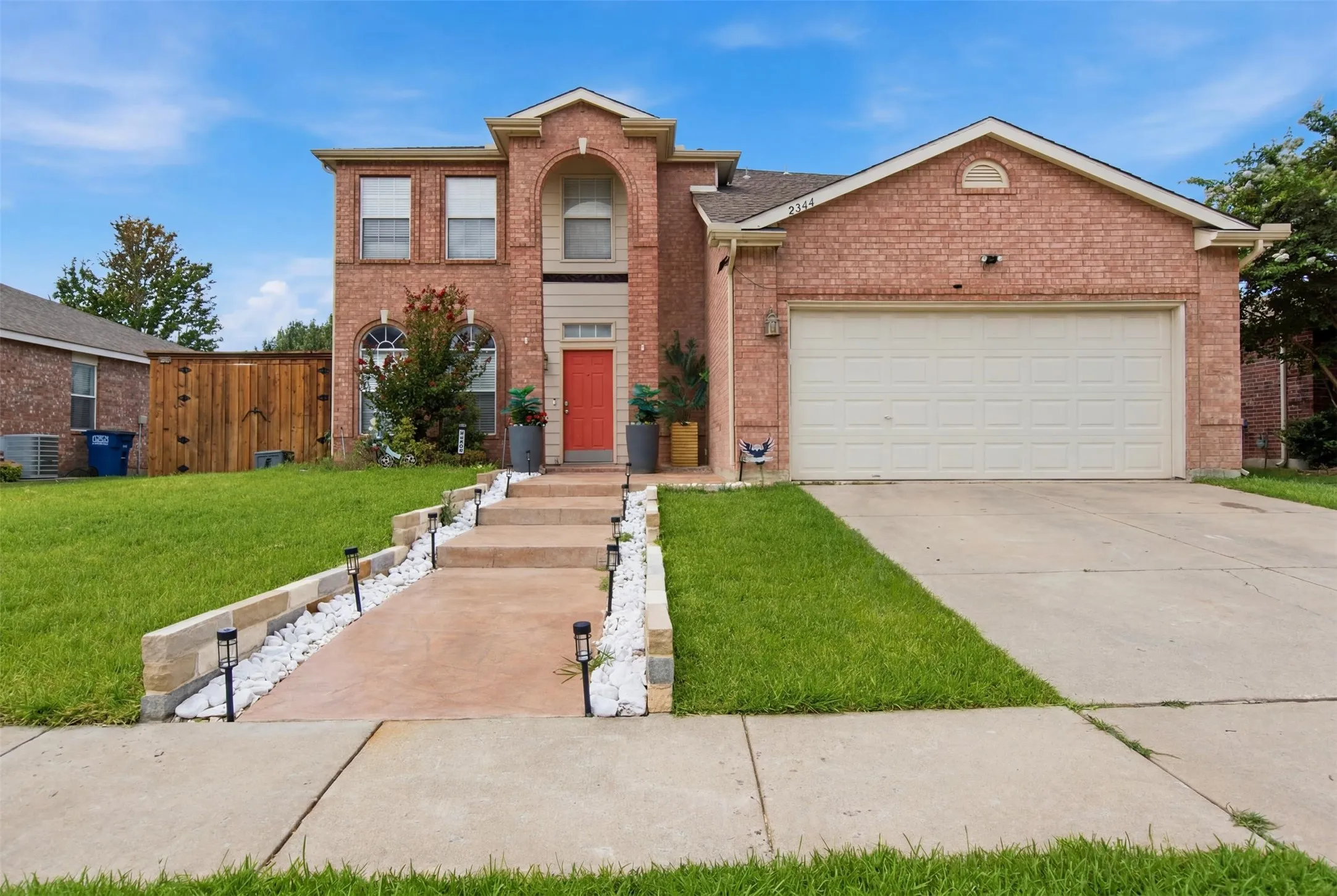 Red brick exterior with a prominent arched entry