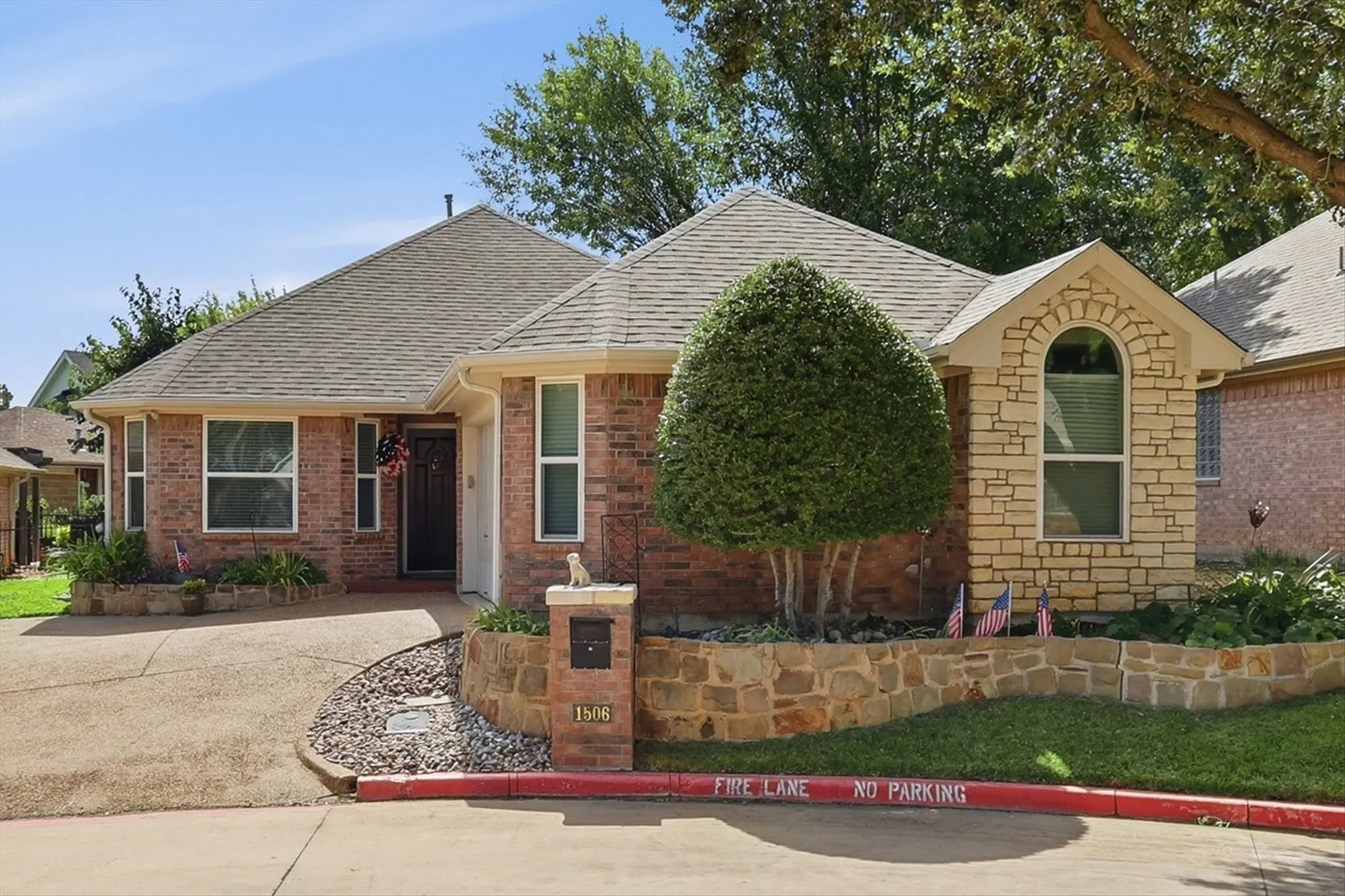 Brick and stone-veneer exterior with a shingle roof