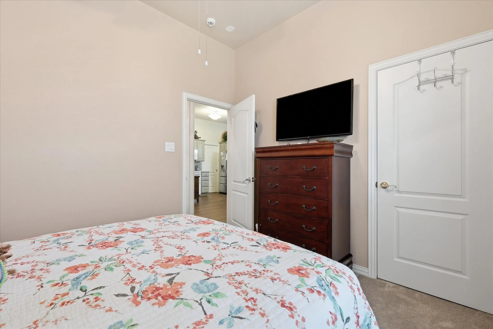 Neutral-toned walls complement plush carpeting