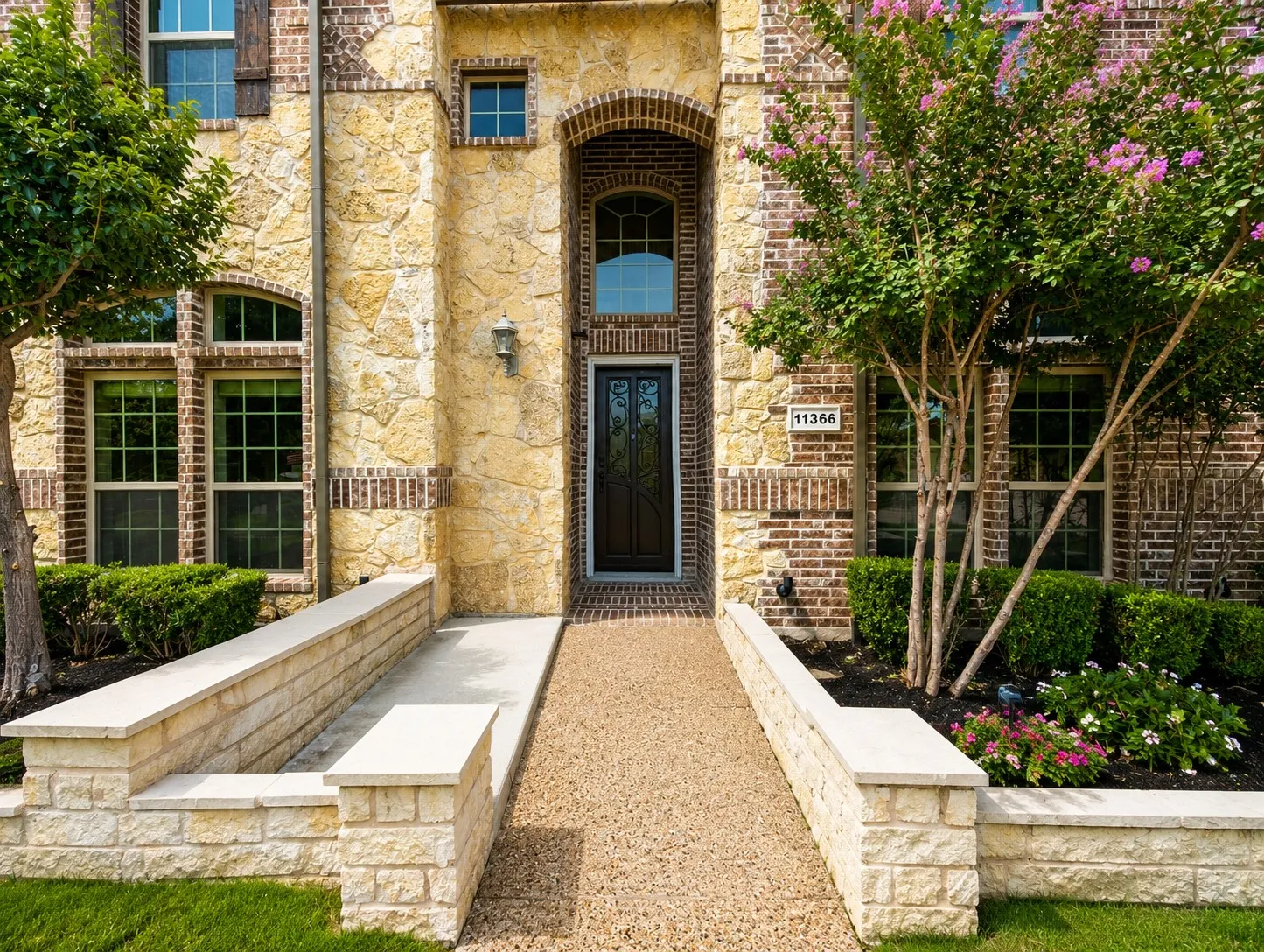 Stone and brick facade featuring a central arched entryway