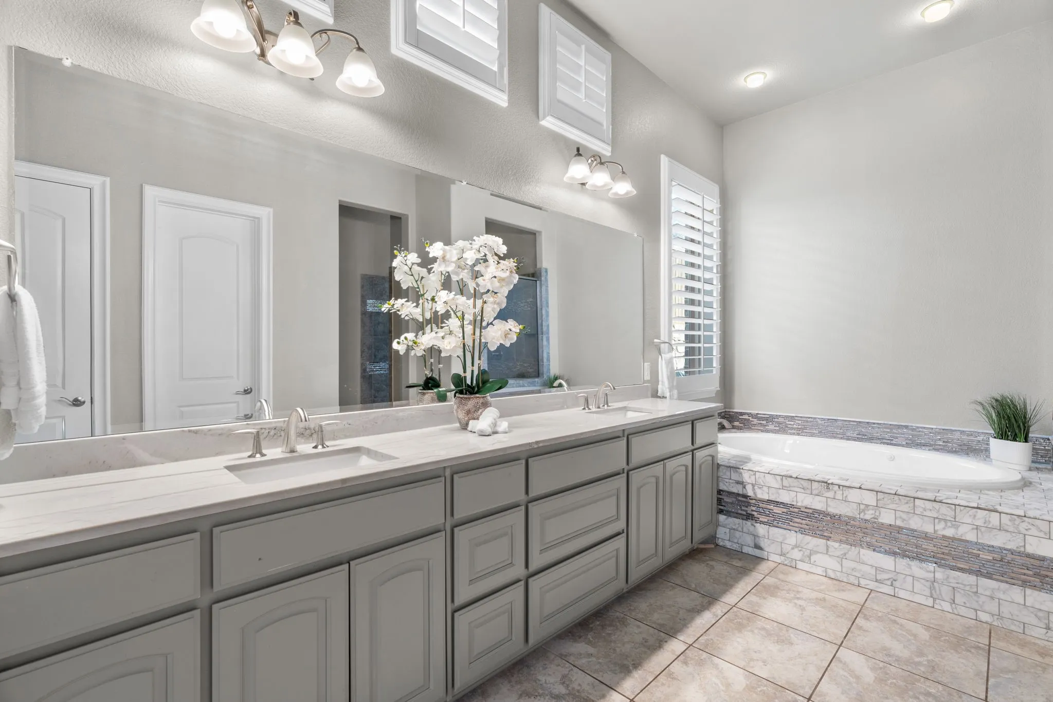Master Bathroom featuring two sinks and big walk in shower