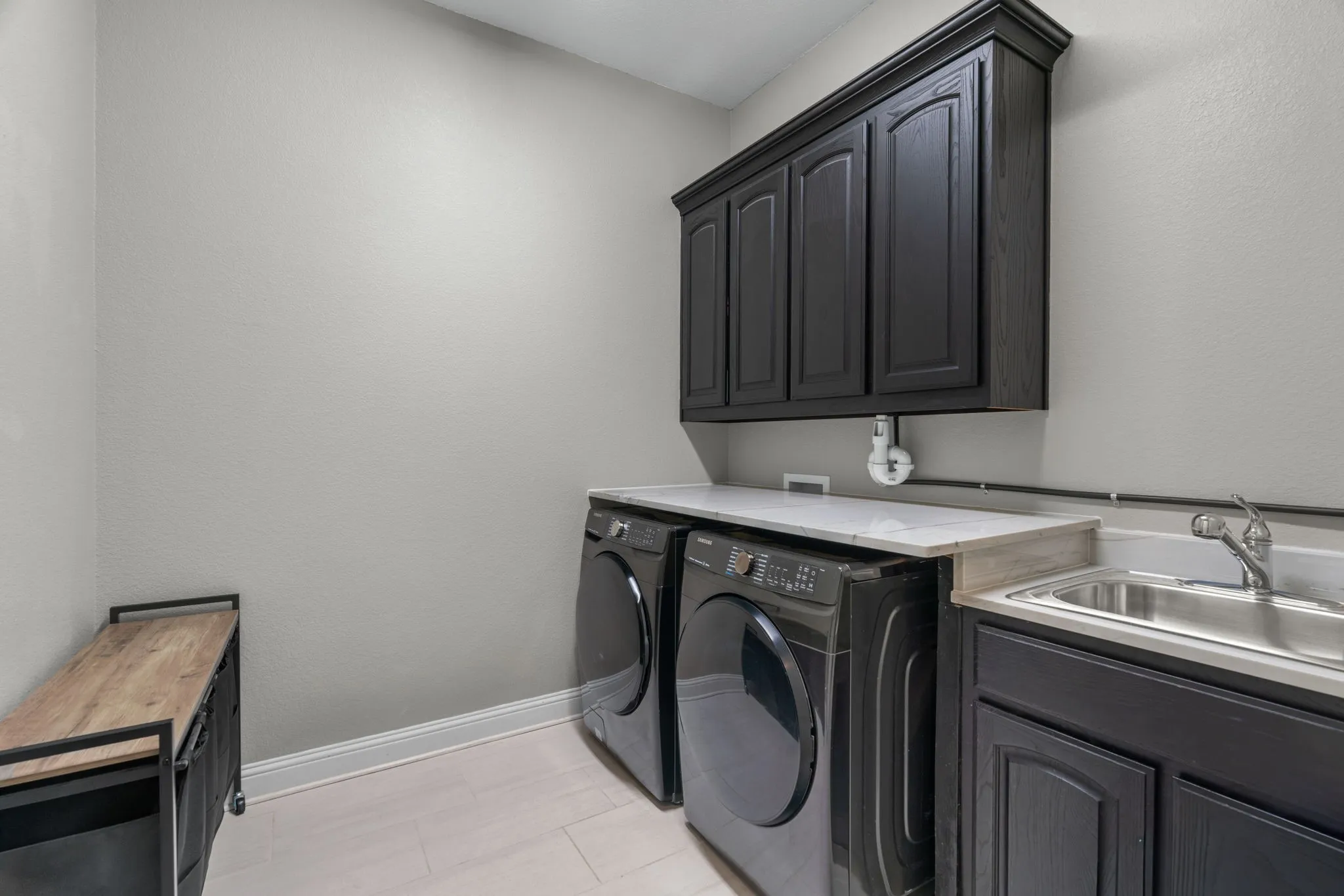 Featuring cabinets, sink and room for a fridge