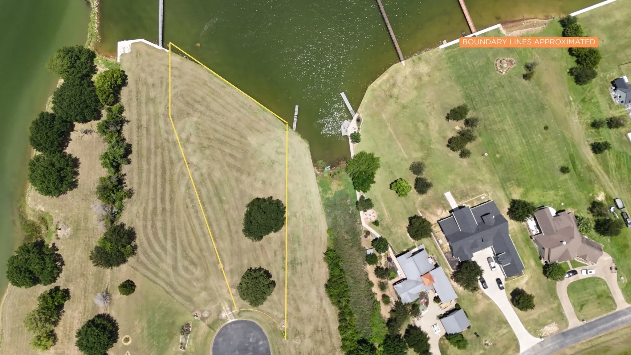 Aerial view illustrates generous lot width and premium waterfront positioning.